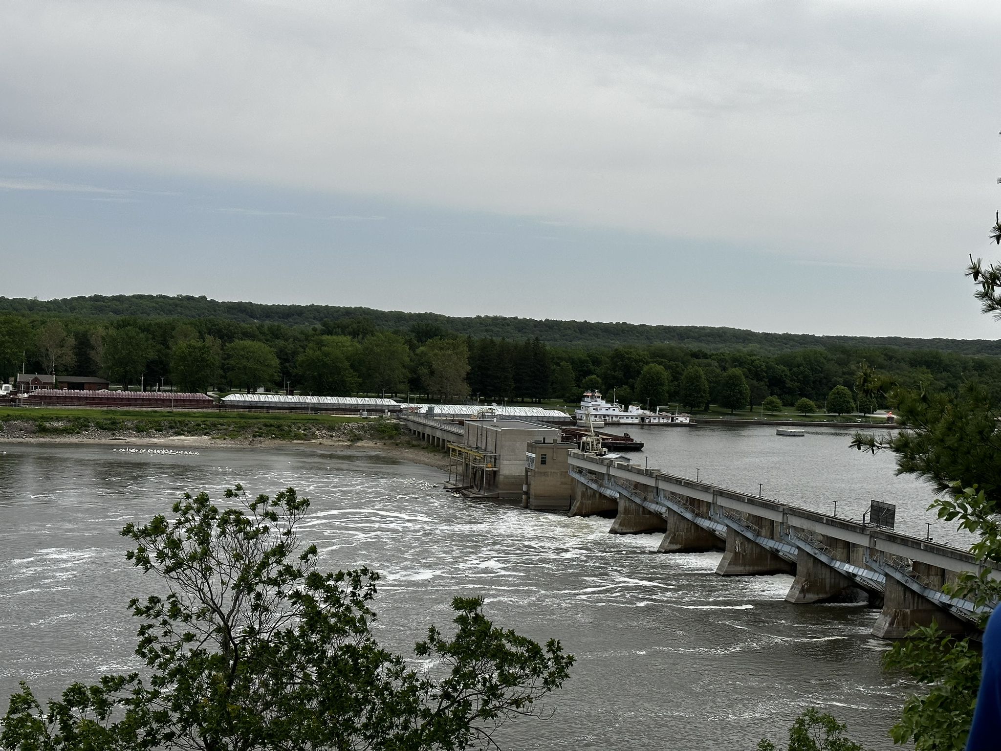 Large dam spanning a wide river under an overcast sky, with forested banks. - French Canyon