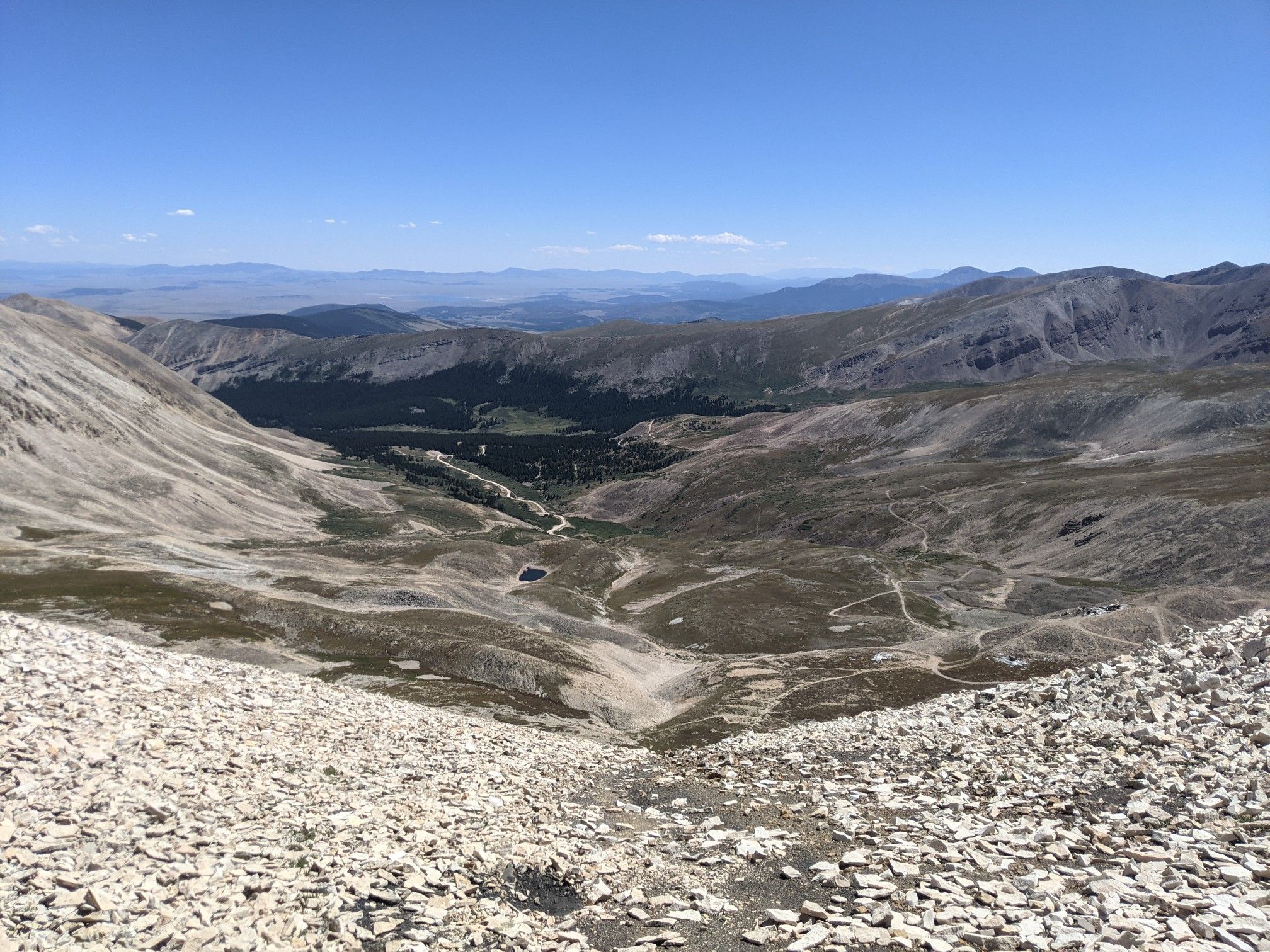 Expansive rocky mountain valley with a small lake under a clear sky. - Mount Sherman - Southwest Ridge from Fourmile Creek