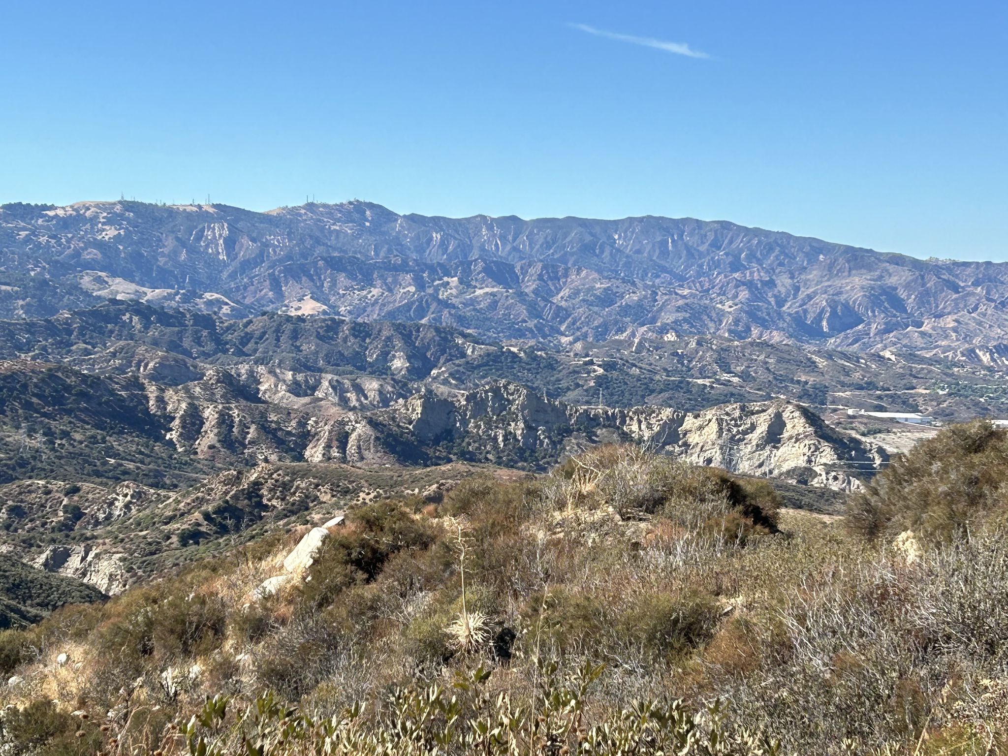 Vast, rugged mountain range under a clear, bright blue sky. - Santa Clara Trail – Whitney Canyon Park loop from MRCA Open Space