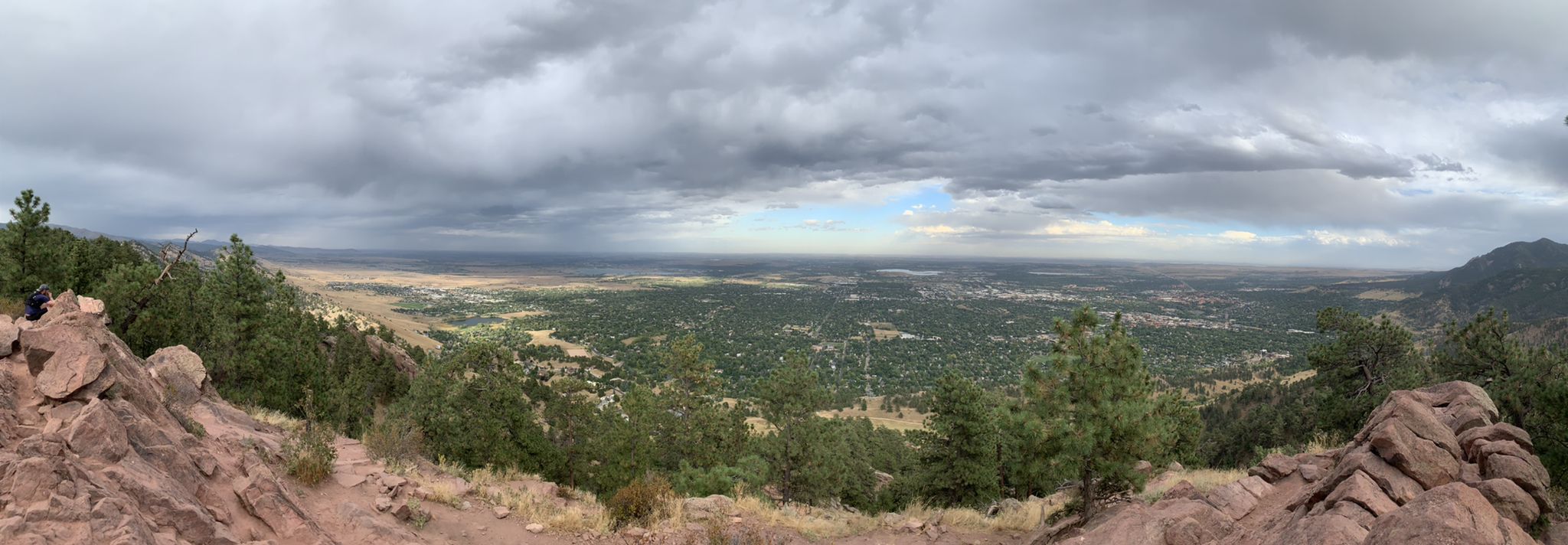 Panoramic view of a vast valley and distant city under cloudy sky. - Mount Sanitas and Lion's Lair Loop