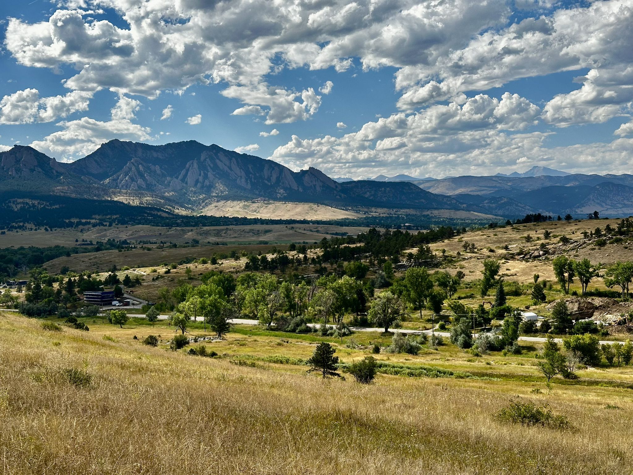 Panoramic view of a valley with mountains under a partly cloudy sky. - Meadowlark Trail – Community Ditch Trail loop from Flatiron Crossing