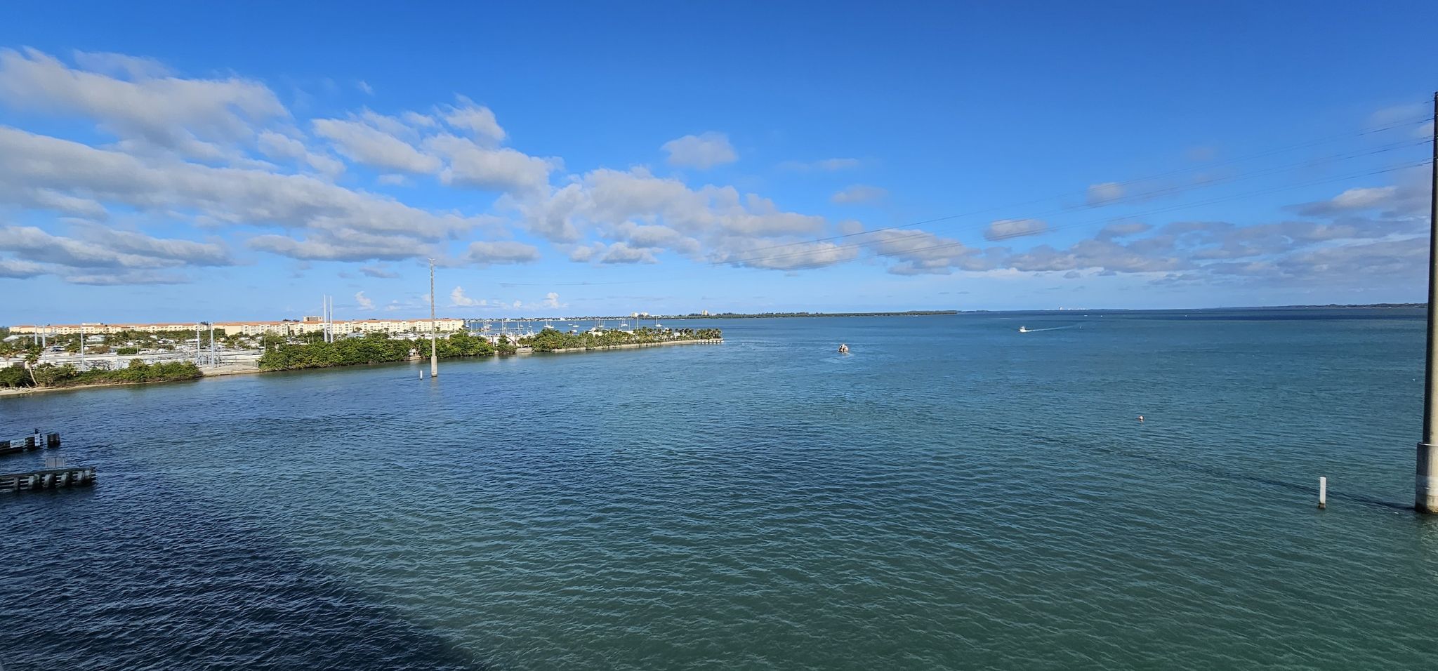 Expansive blue water with distant land and a bright blue sky with clouds. - Jensen Beach to Fort Pierce loop