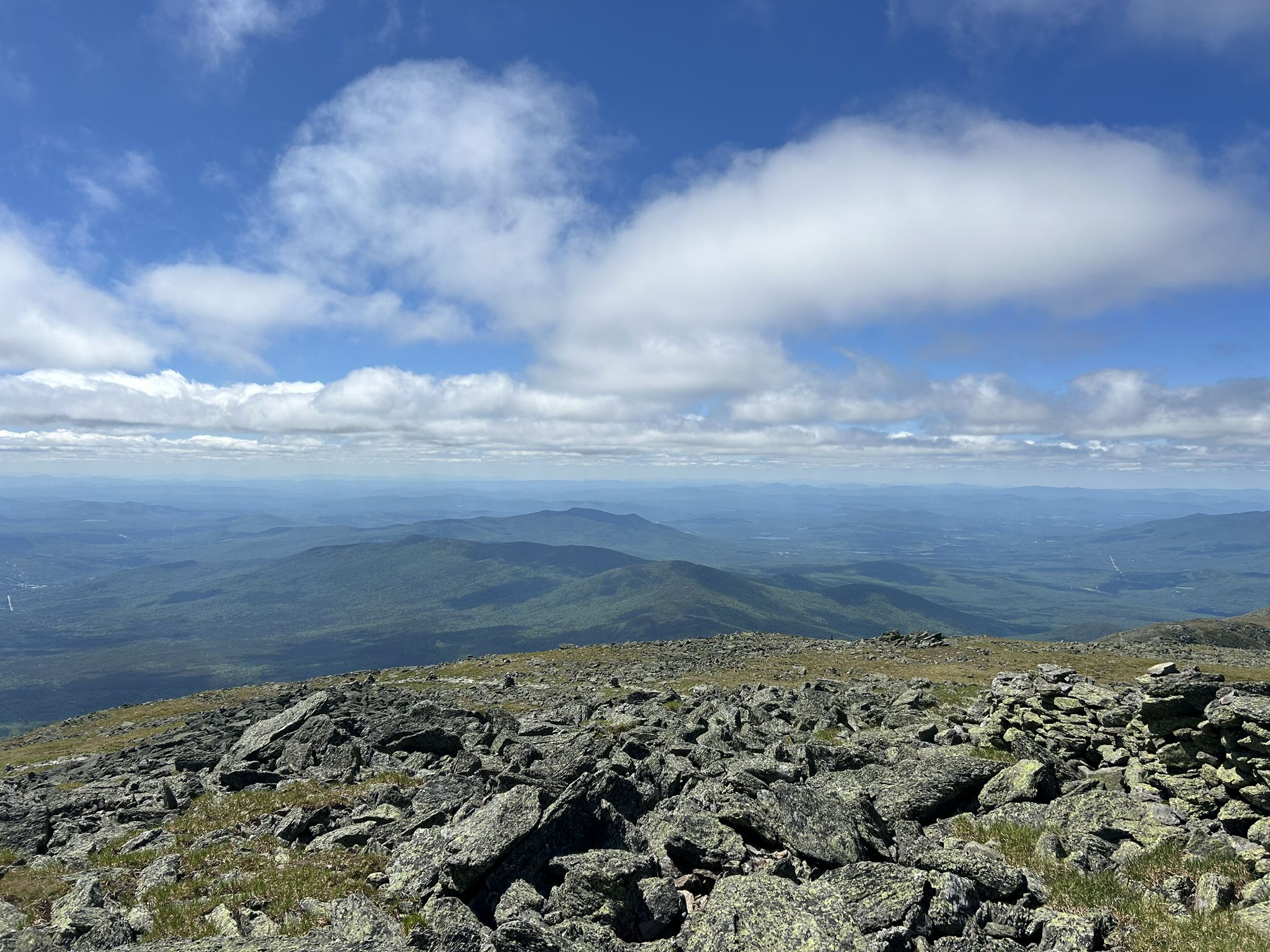 Expansive rocky mountain landscape under a bright blue sky with clouds. - Mount Washington Summit Loop Trail