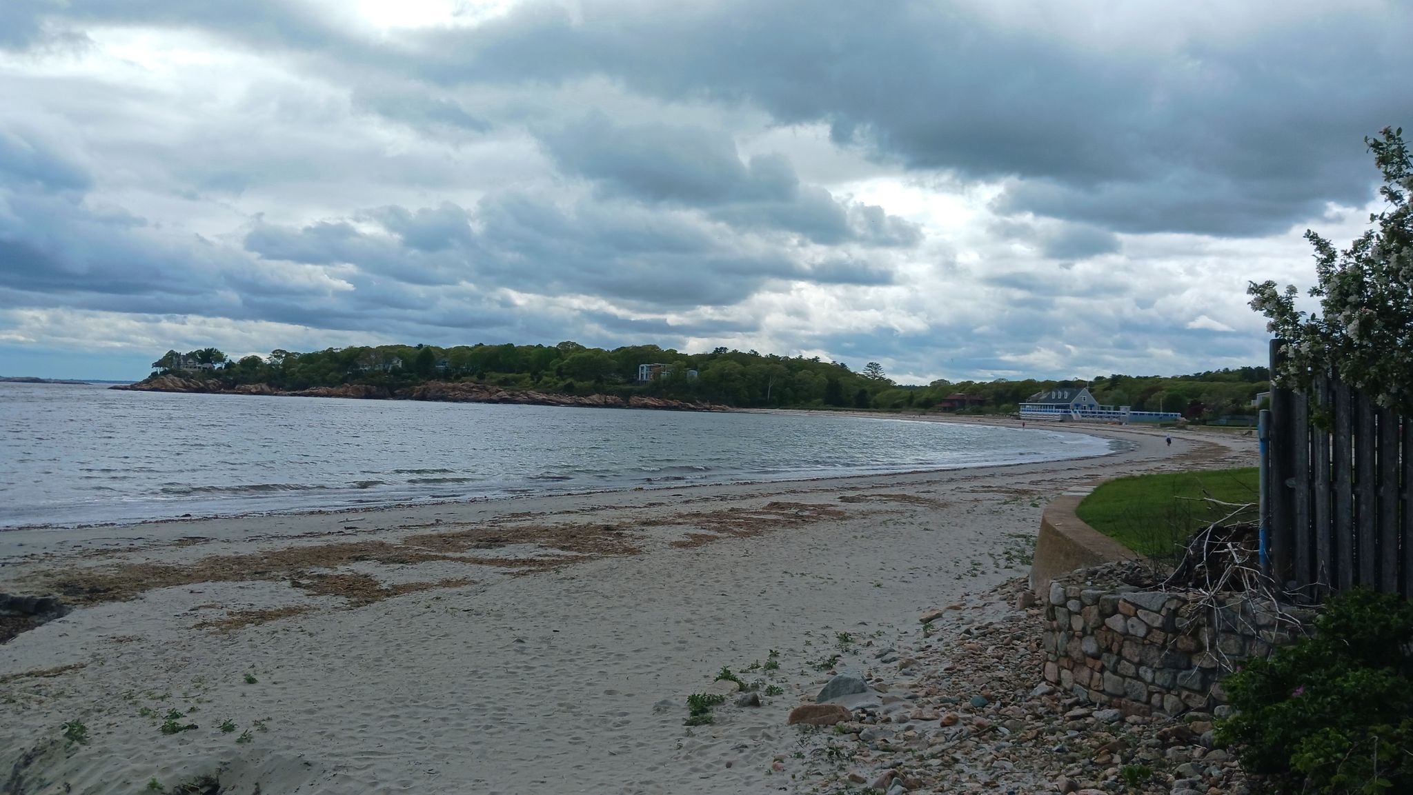 Overcast day at a wide sandy beach with calm ocean and distant land. - Ravenswood Park – Gray Beach and Magnolia Pier loop from Coolidge Reservation