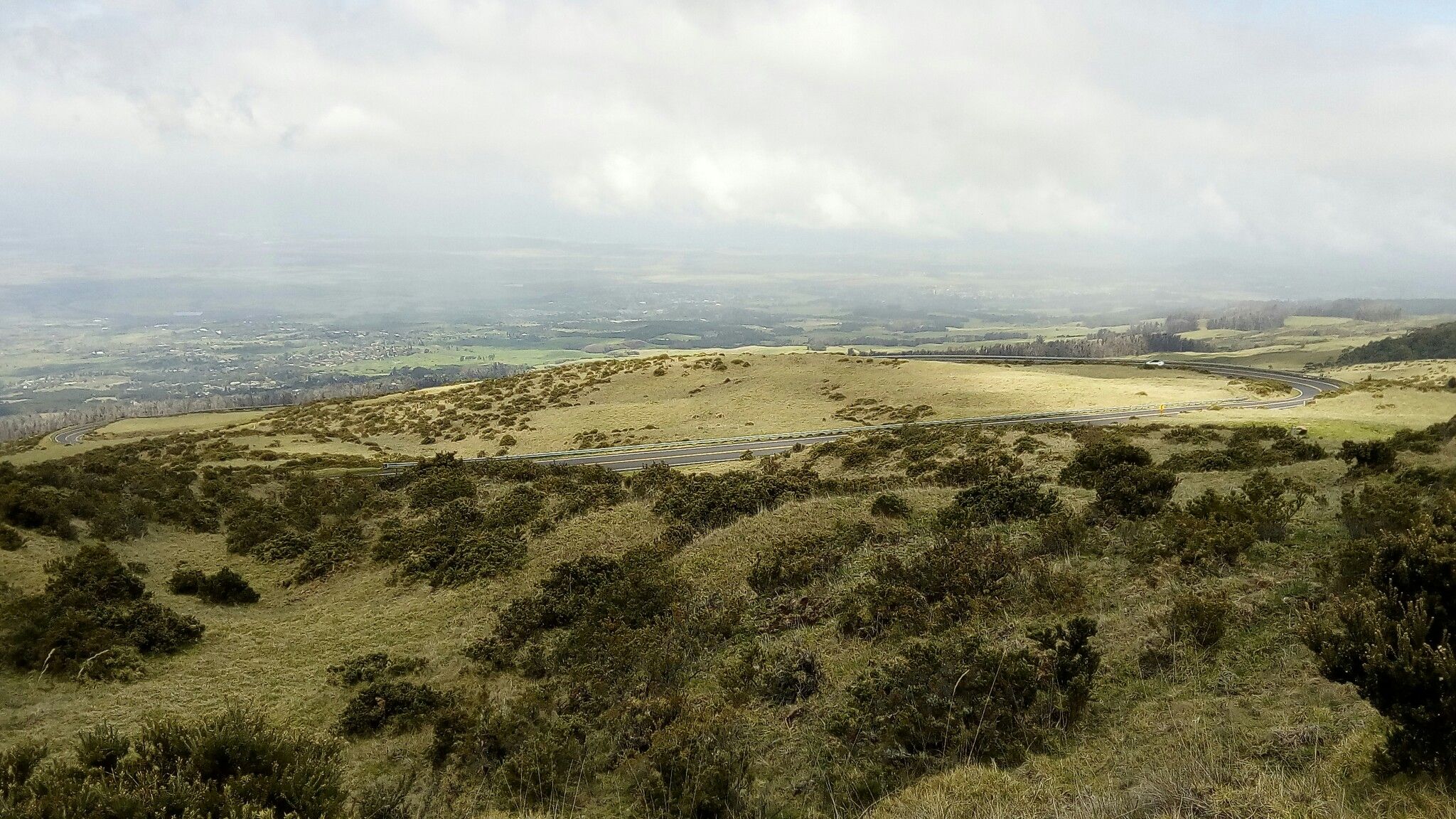 Expansive view of rolling, brush-covered hills under an overcast sky. - Haleakalā National Park – Crater Road loop from Hula Sandalwoods Cafe and Inn