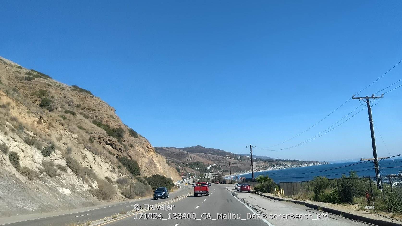 Coastal road with cars, a steep hillside, and the ocean in distance. - Dan Blocker County Beach – Dan Blocker Beach loop from Dan Blocker County Beach
