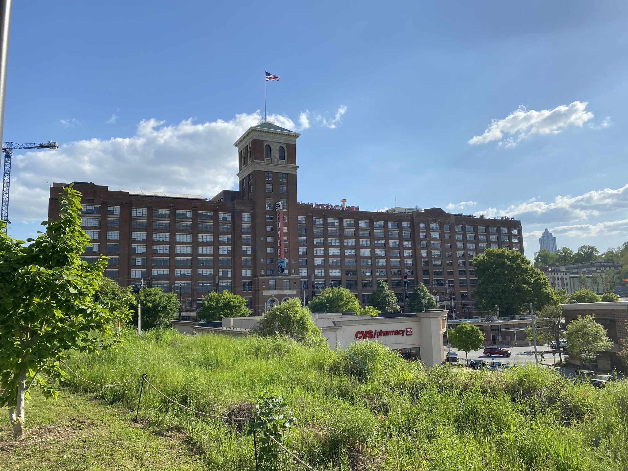 Large brick building with a tower, seen from a grassy hillside. - Atlanta Beltline and Decatur Trails Loop