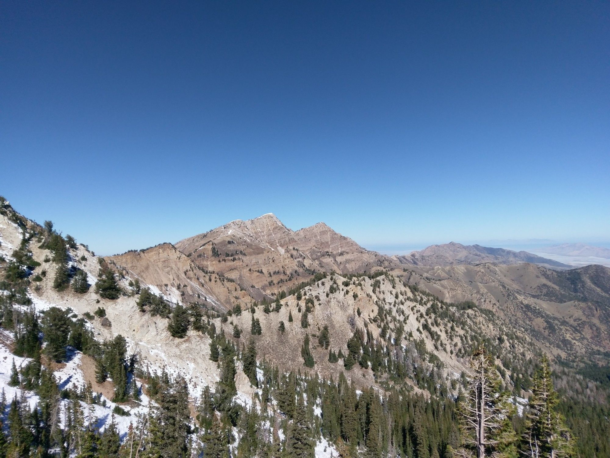 Rugged mountain peaks with patches of snow under a clear blue sky. - Deseret Peak via Mill Fork Canyon Trail — Deseret Peak Wilderness