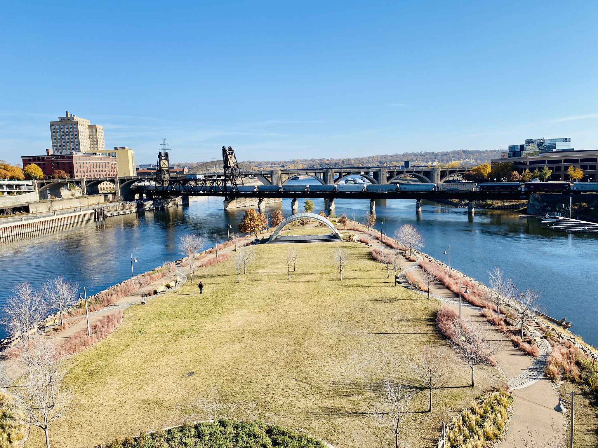 Wide river with multiple bridges and urban skyline under clear blue sky. - St. Paul - Mississippi River Trail Loop