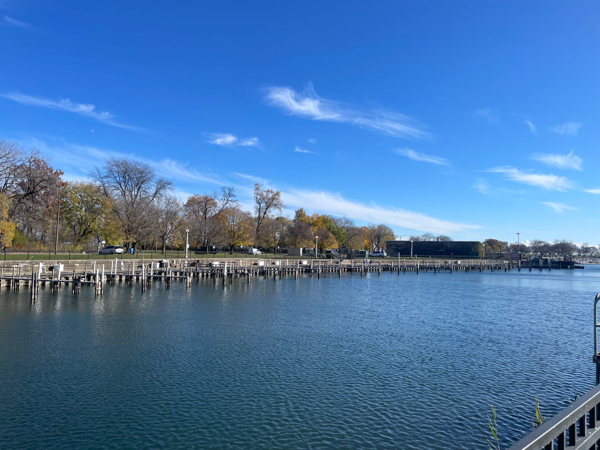 A long wooden pier stretches into blue water under a clear sky. - Fullerton Beach – Lincoln Park loop from Dempster