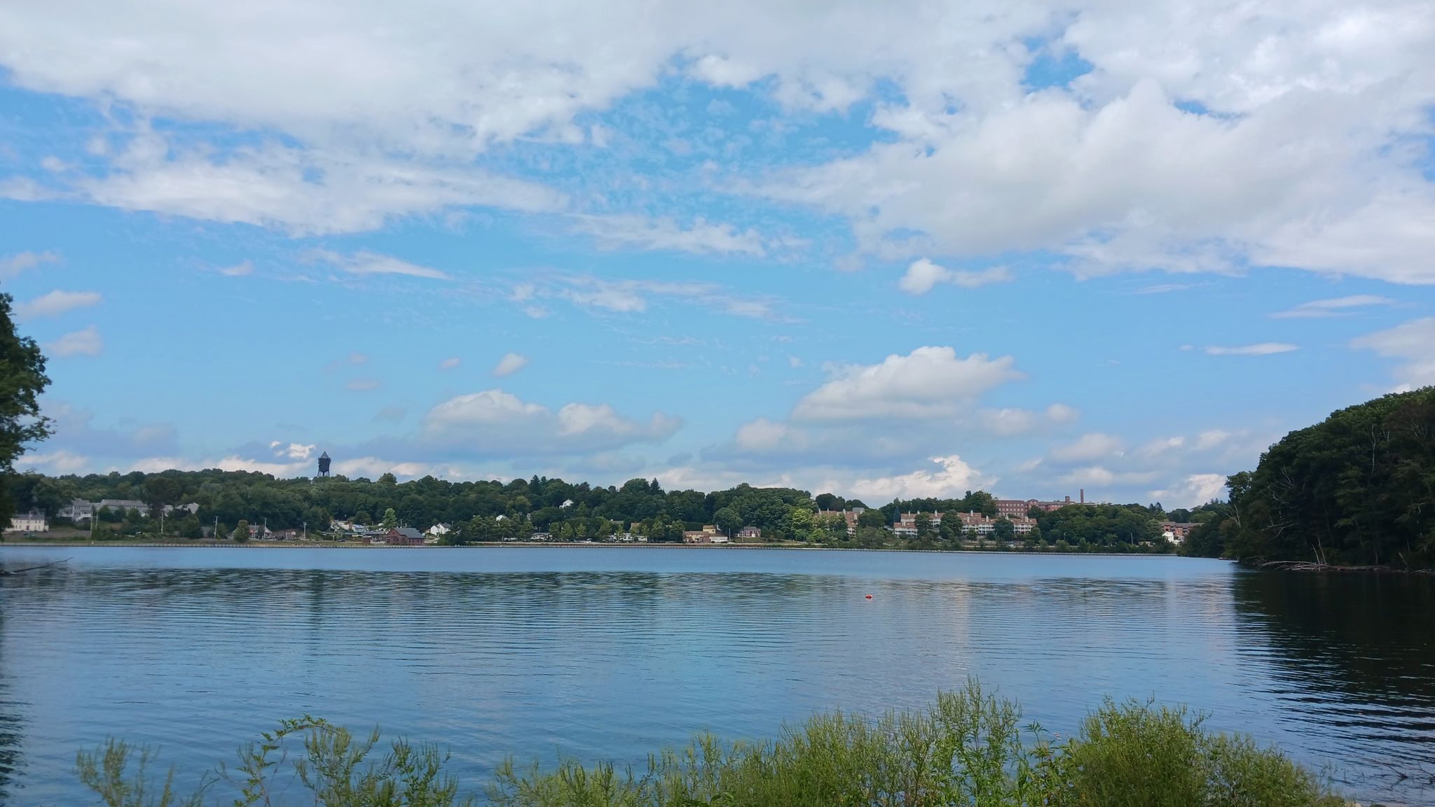 Calm lake reflecting a blue sky with white clouds, distant shore. - Lake Williams Boardwalk loop from Marlborough