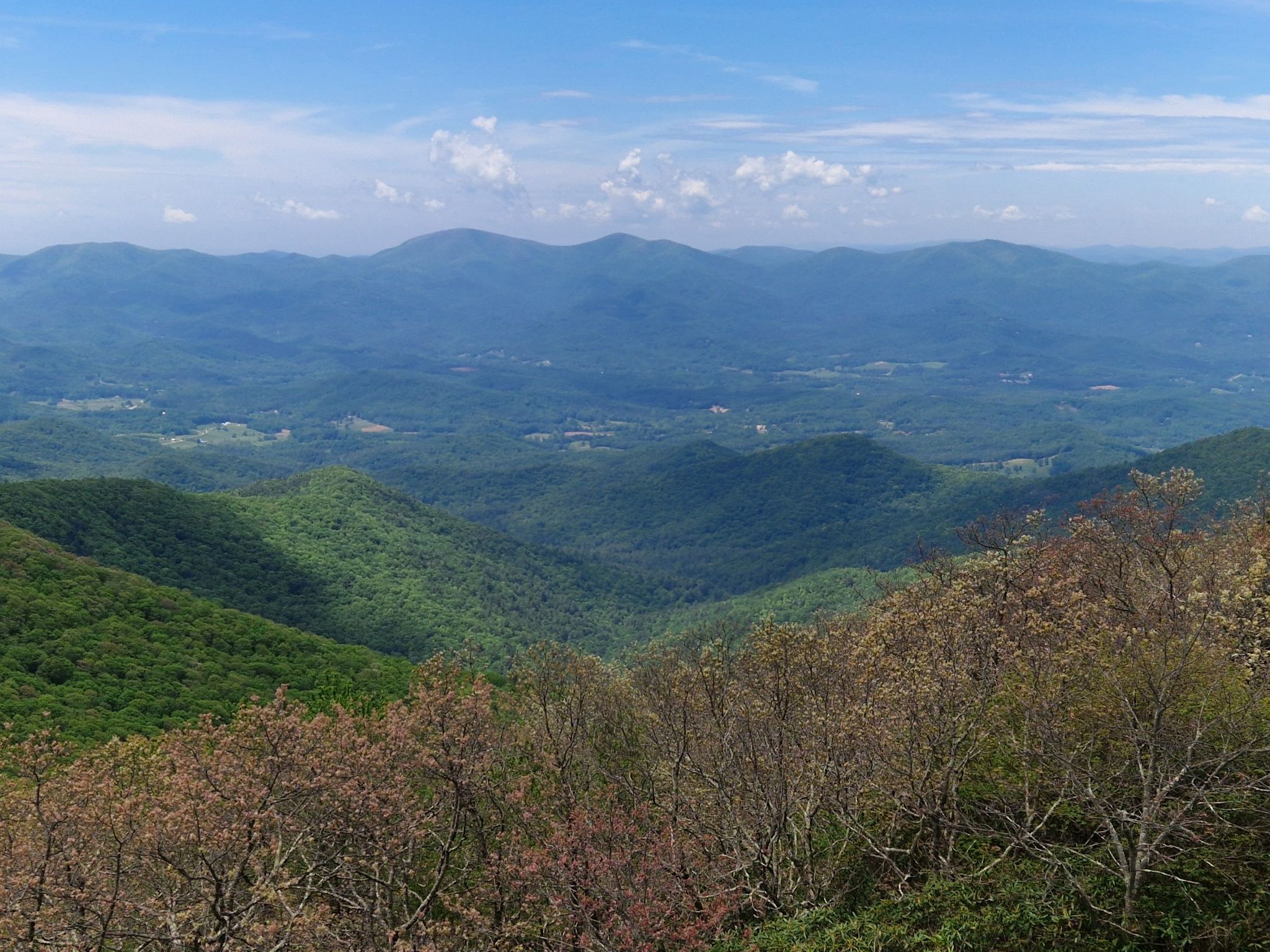 Vast landscape of green forested mountains and valleys under a partly cloudy sky. - Brasstown Bald via Jacks Knob Trail