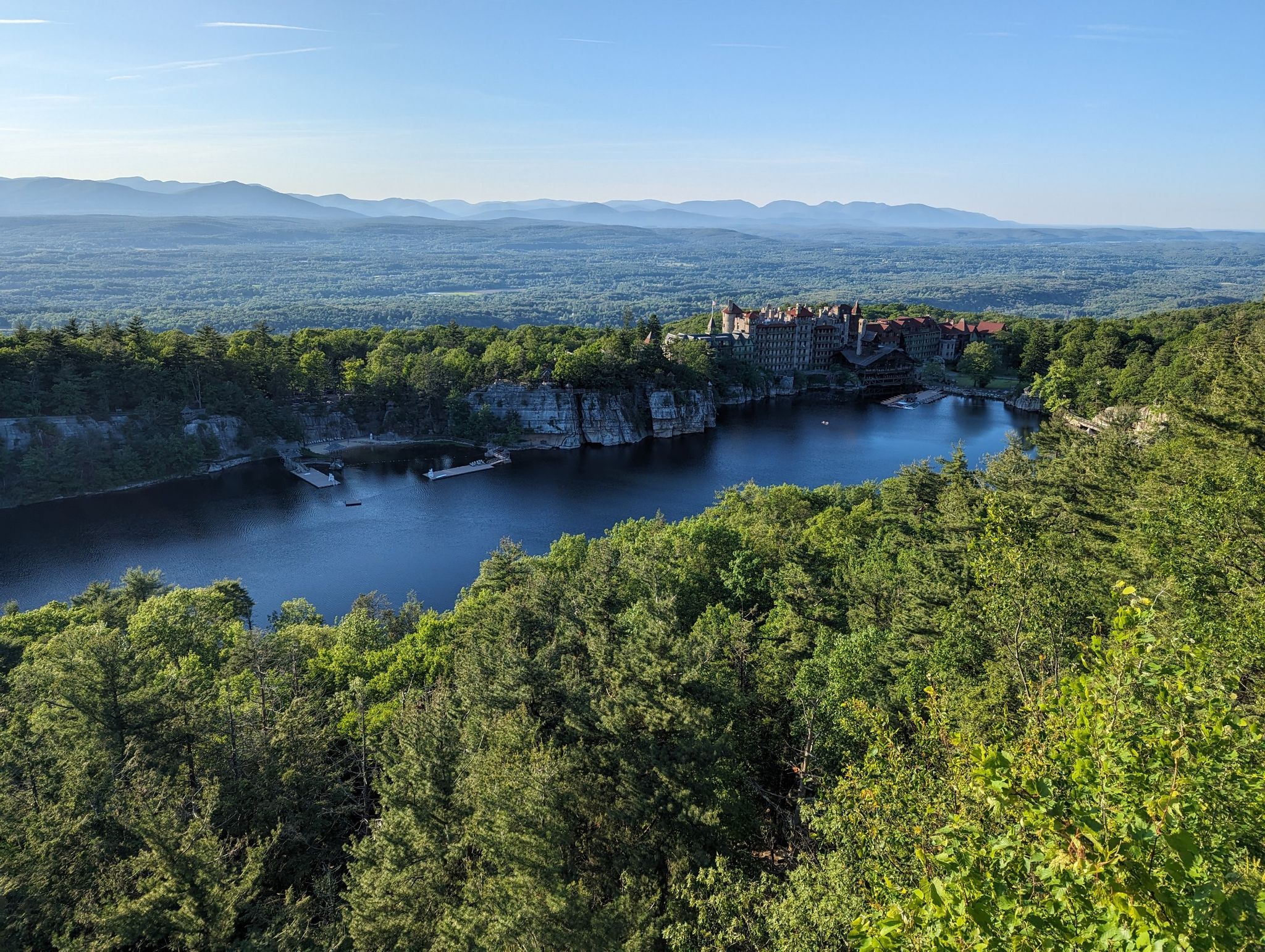 Aerial view of a large lake, forest, and distant mountains on a clear day. - Lemon Squeeze and Eagle Cliff