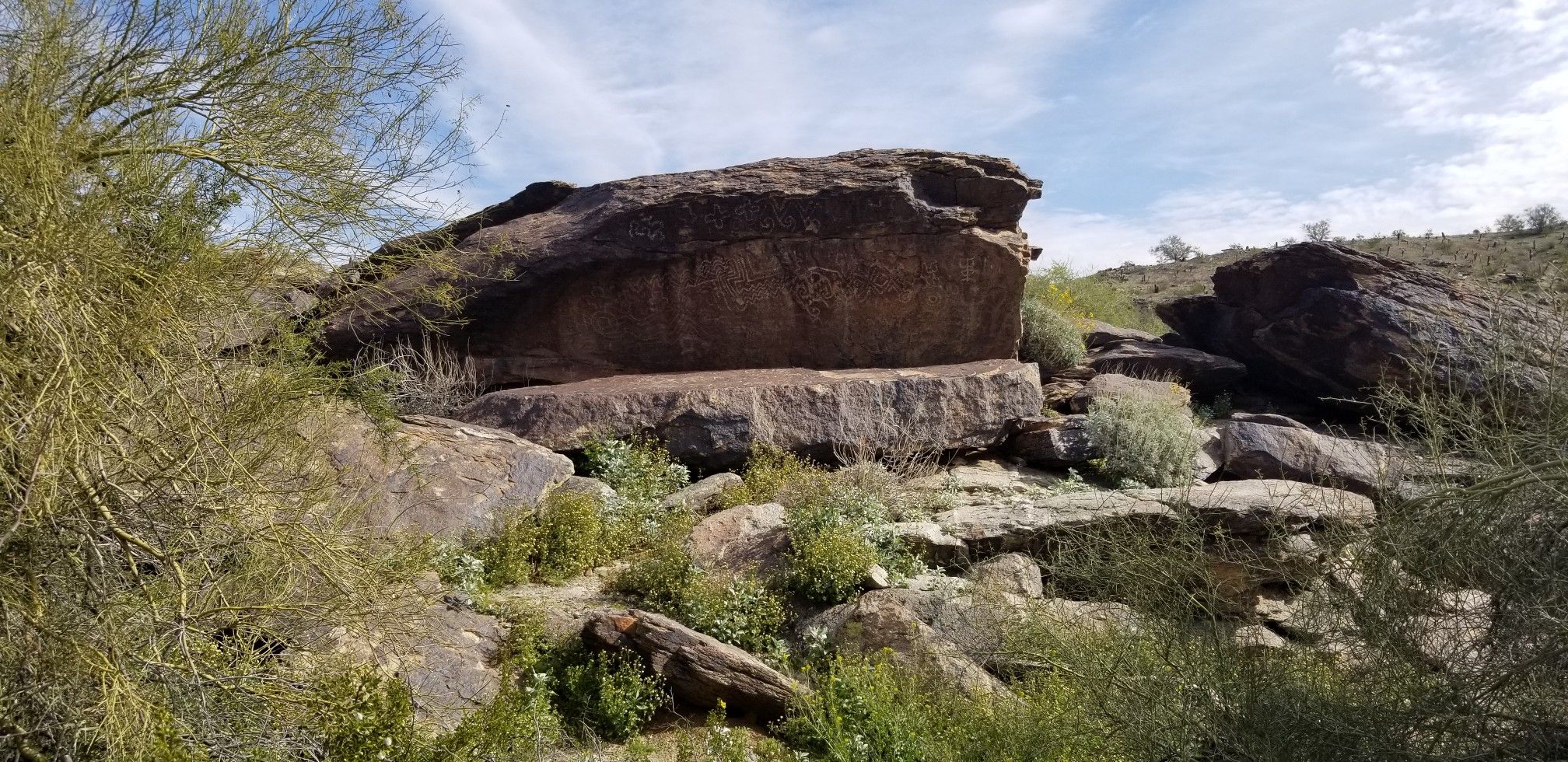Large rock formation in a rocky desert landscape under bright daylight. - Stone Arch Bridge – Pima Canyon Trailhead loop from Guadalupe