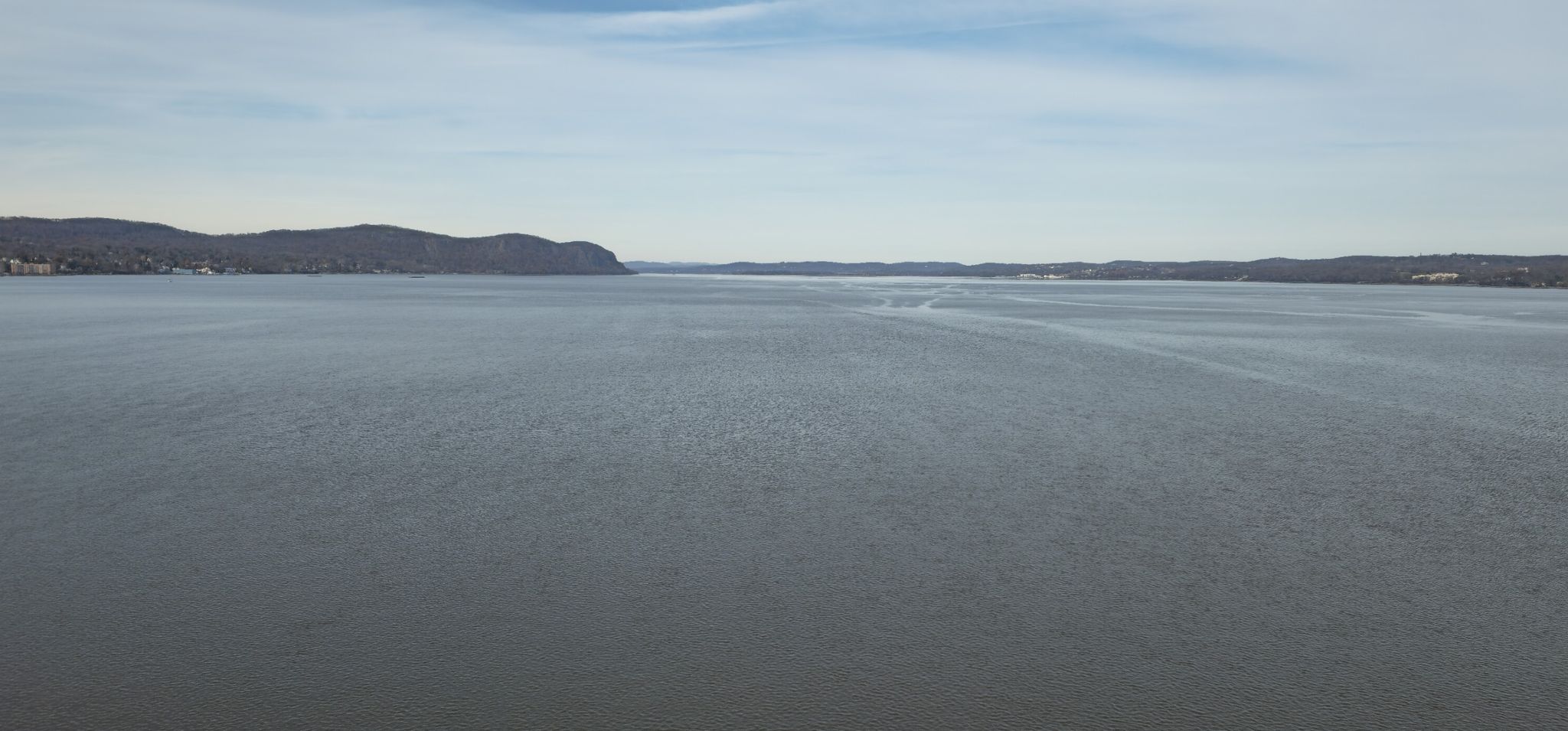 Wide expanse of calm water with distant hills under a partly cloudy sky. - Painters Point loop from Nyack