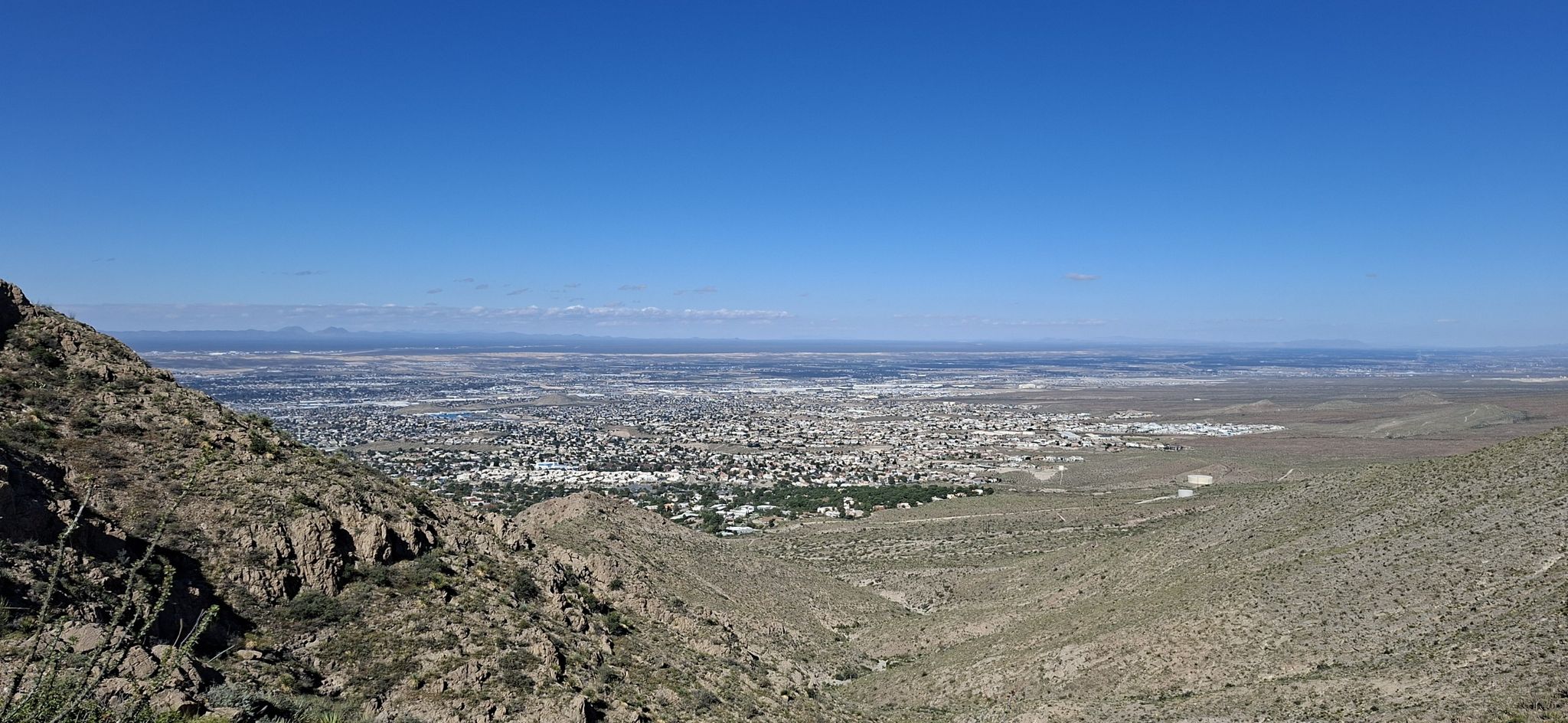 Panoramic view of a sprawling city from a rocky, arid mountain. - Ron Coleman Trail from McKelligon Canyon