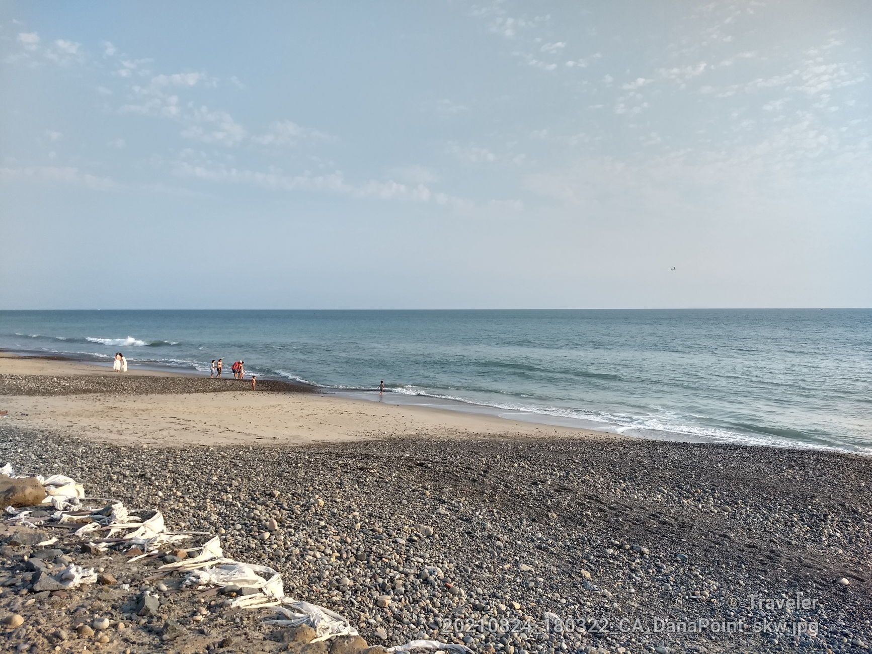 A rocky and sandy beach with people near the ocean under a bright sky. - Doheny State Beach – North Beach loop from Capistrano Beach