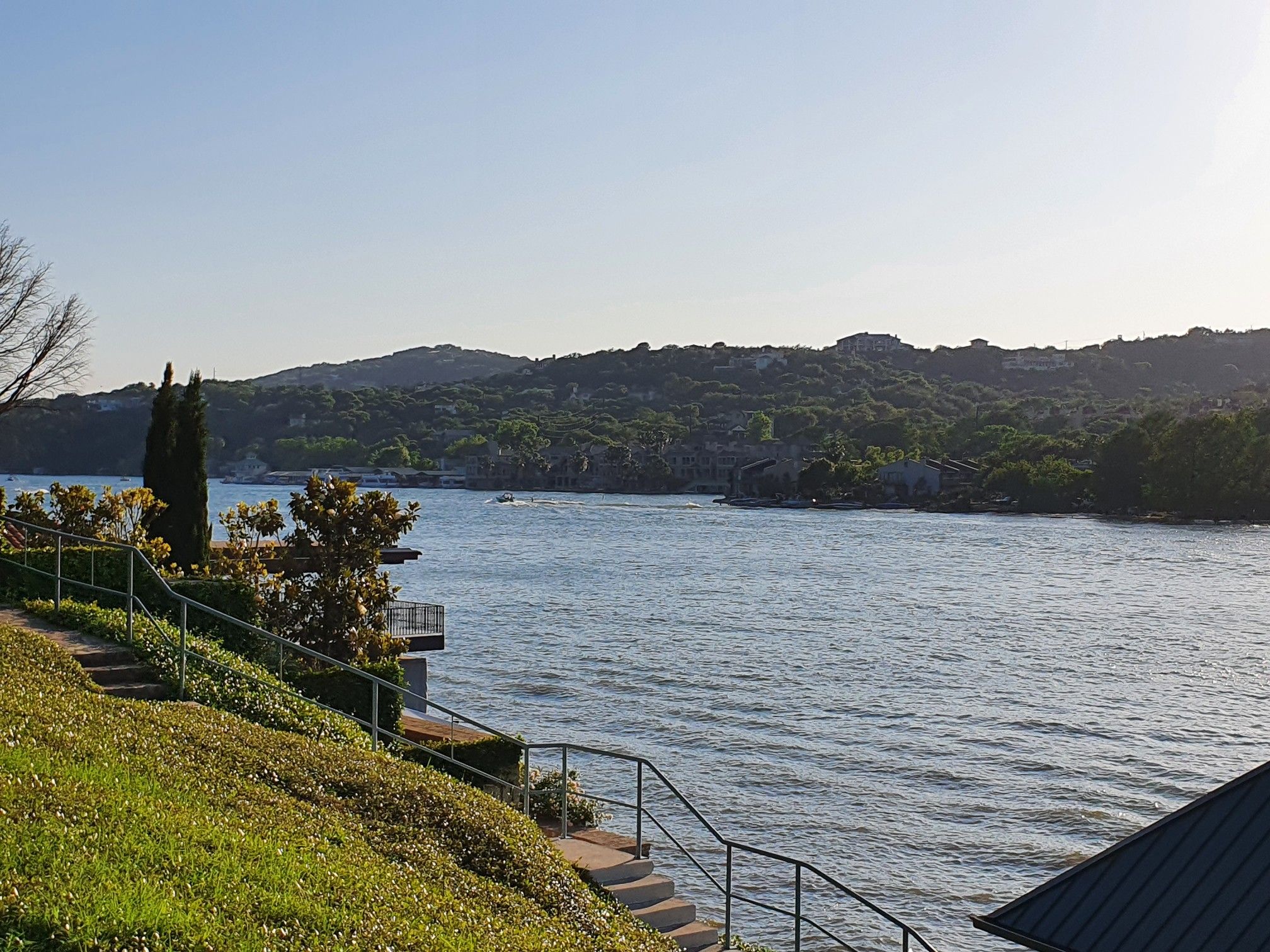 A wide lake view with green hills and a grassy slope with stairs. - Mellow Johnny's Early Morning Tuesday loop