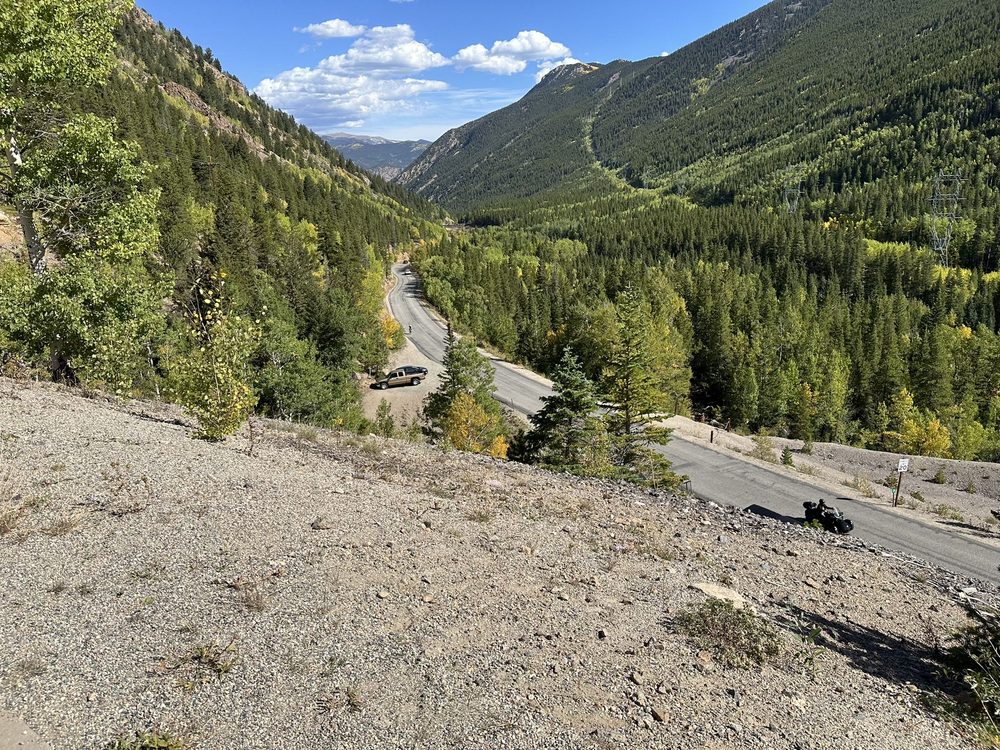 Winding mountain road through a green valley under a clear sky. - Idaho Springs to Guanella Pass Summit