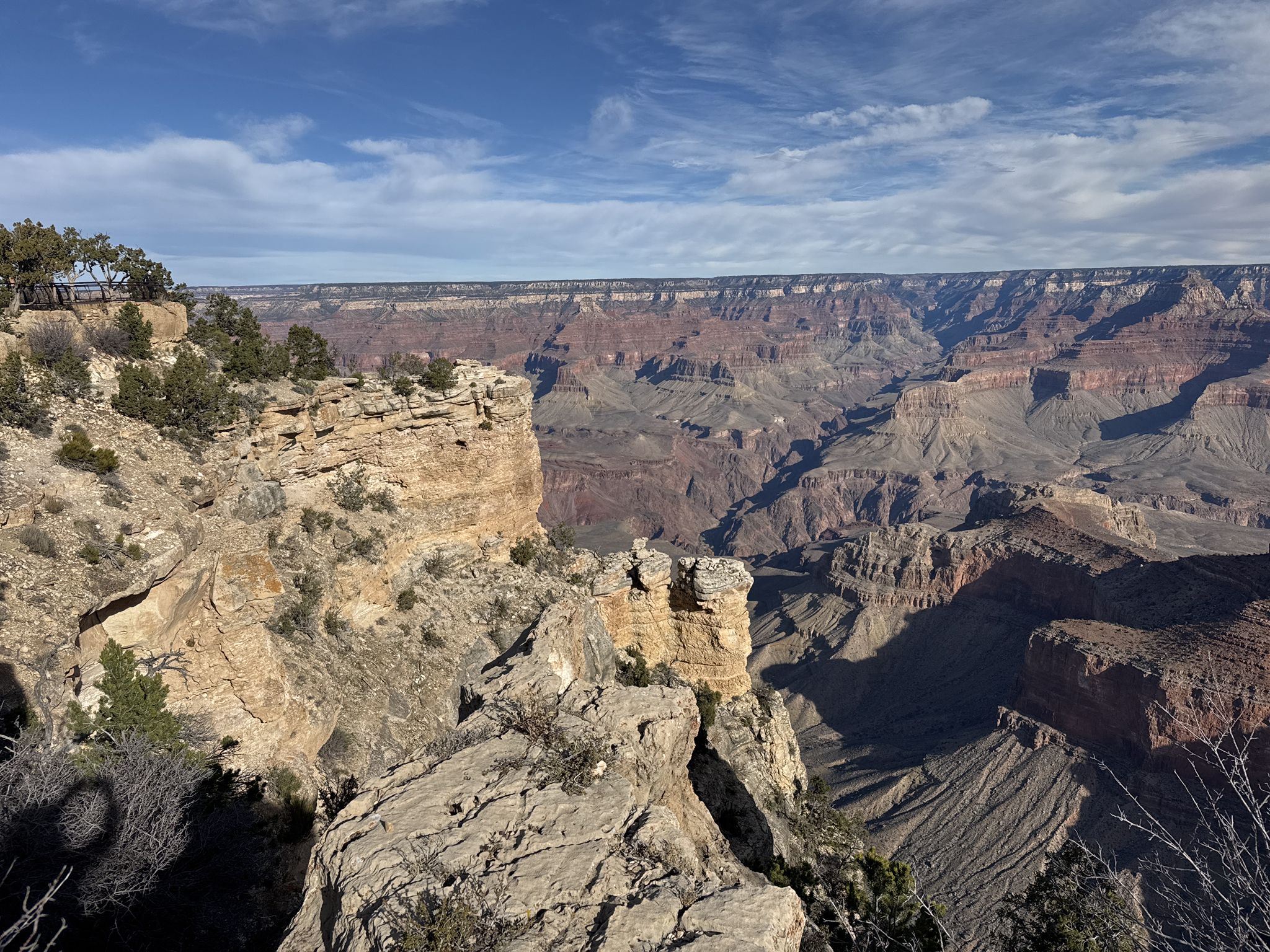 Expansive canyon view with layered rock formations under a partly cloudy sky. - South Kaibab Trailhead – Ooh Aah Point loop from Grand Canyon Village