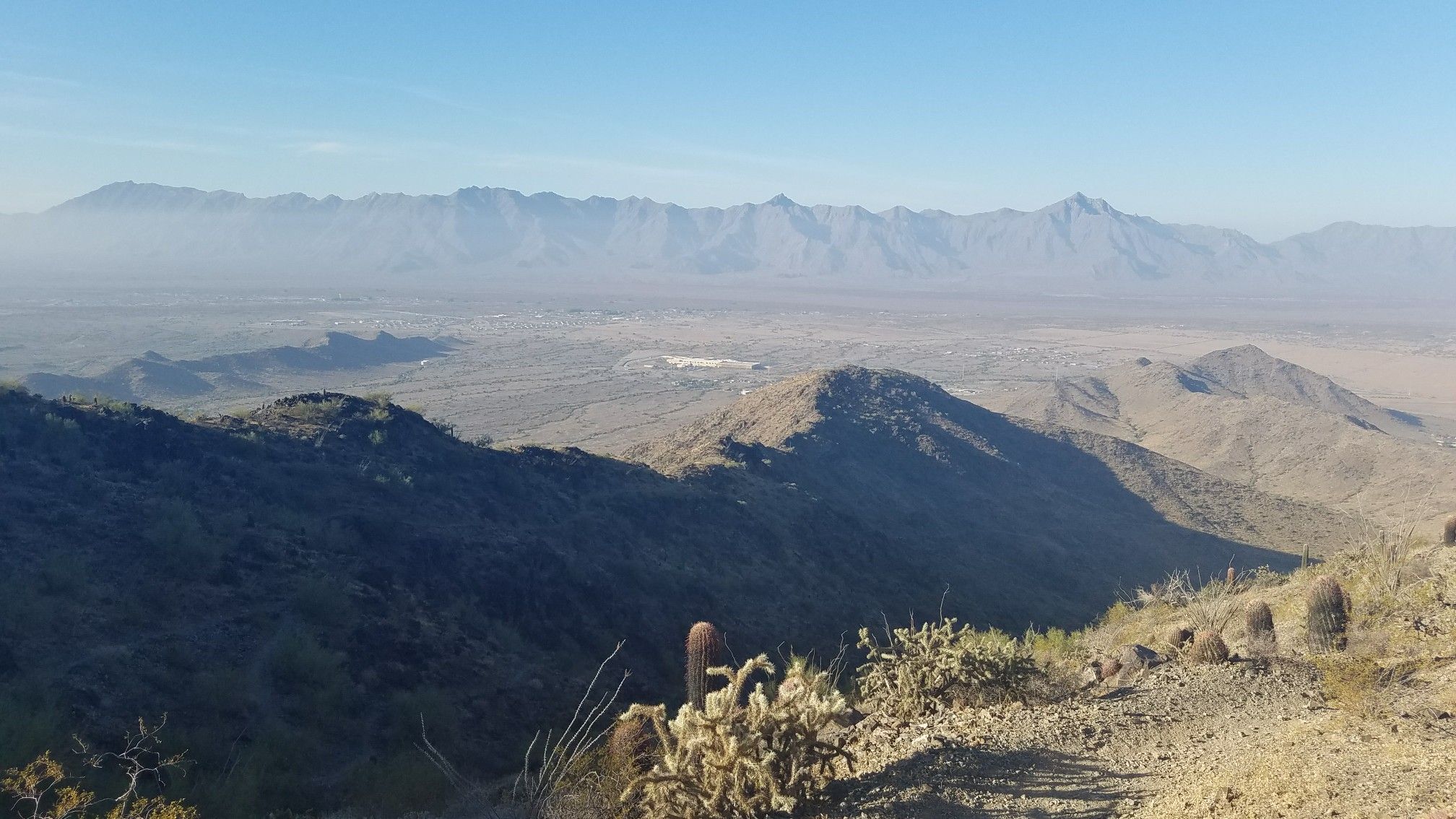 Vast desert valley with distant mountains under a clear blue sky. - Alta-Bajada Loop