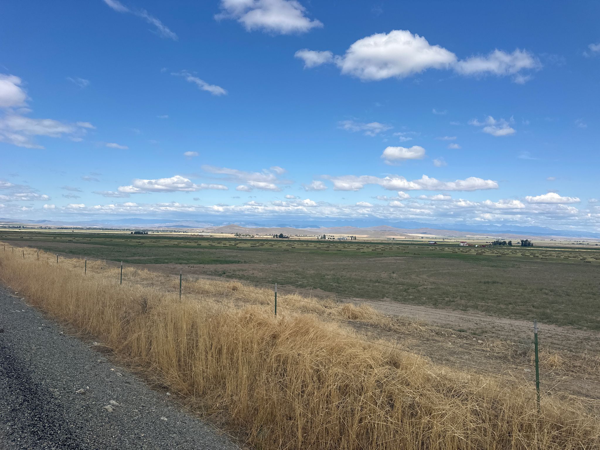 Wide open fields stretching to distant mountains under a bright blue sky. - Rock Creek Town & Pocahontas Road loop