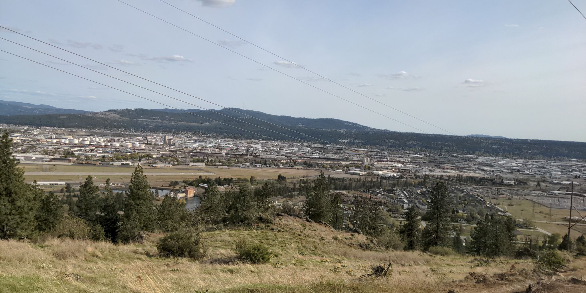 Overhead power lines stretch across a city nestled among distant hills. - Esmeralda Trail Loop