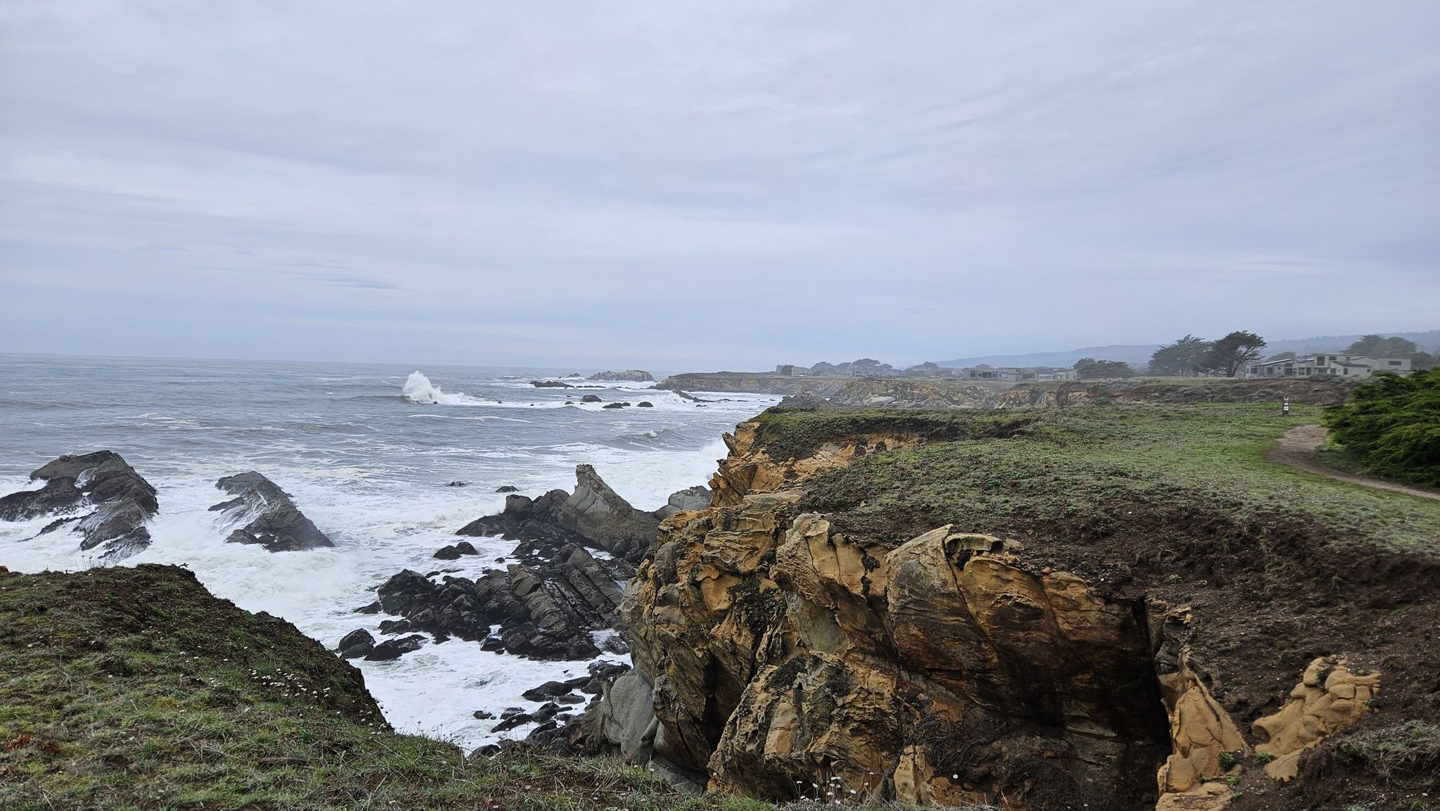 Dramatic rocky coastline with large waves crashing under an overcast sky. - Gualala Point Regional Park loop from Gualala