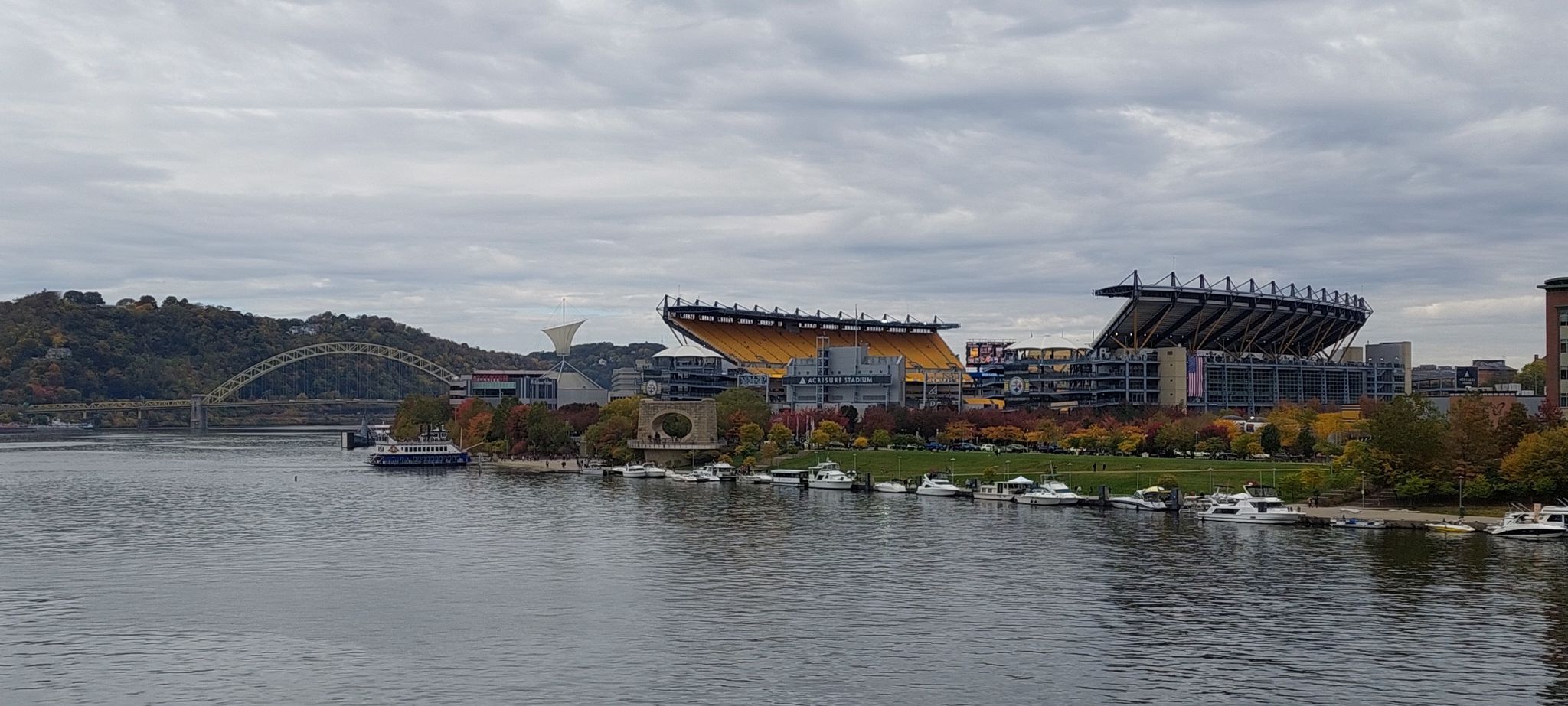 Riverfront stadium and city skyline with autumn trees under cloudy skies. - Three Rivers Heritage Trail Loop