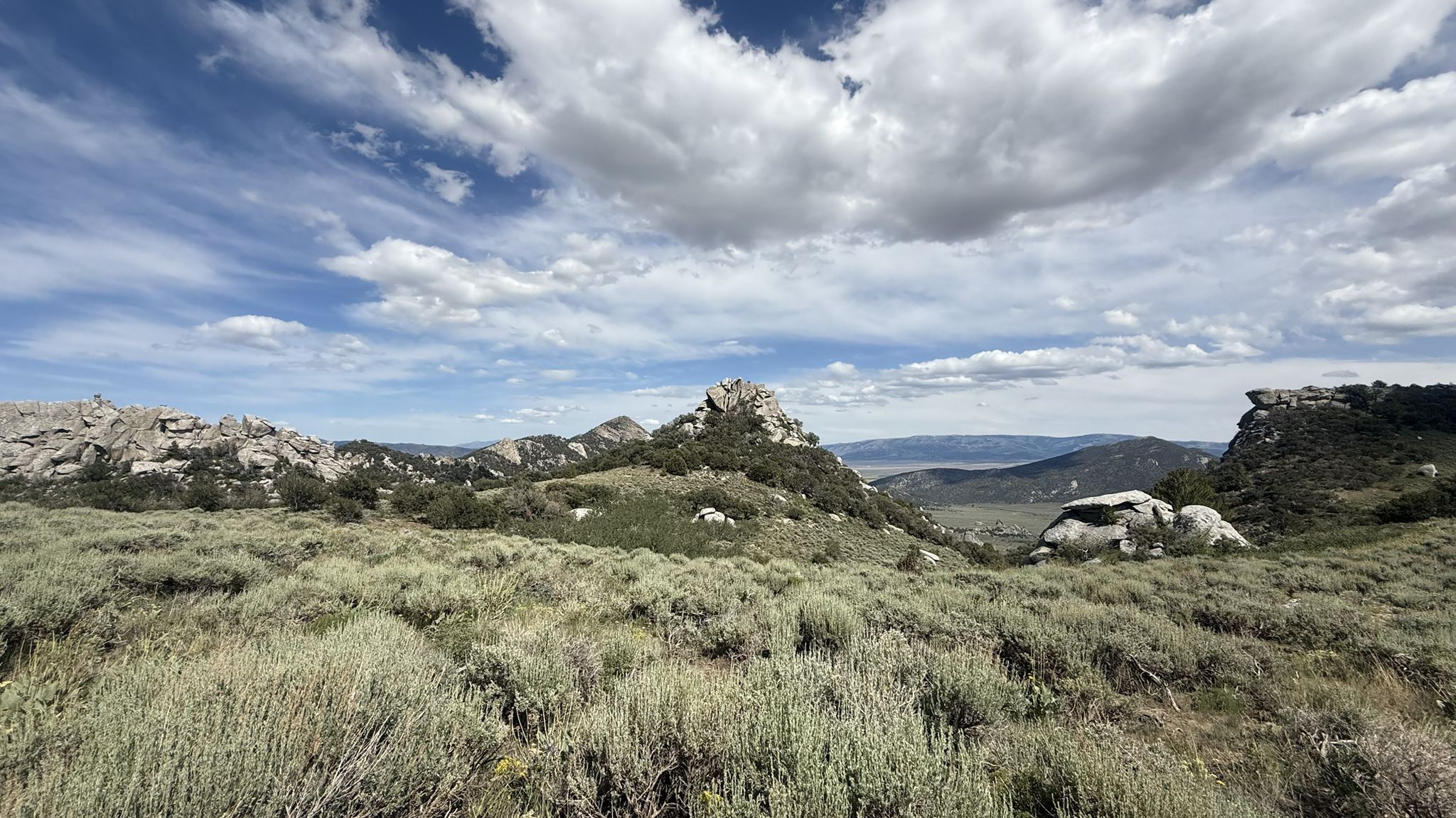 Expansive landscape of sagebrush and rocky outcrops under a dynamic cloudy sky. - Graham Peak via North Fork Circle Creek