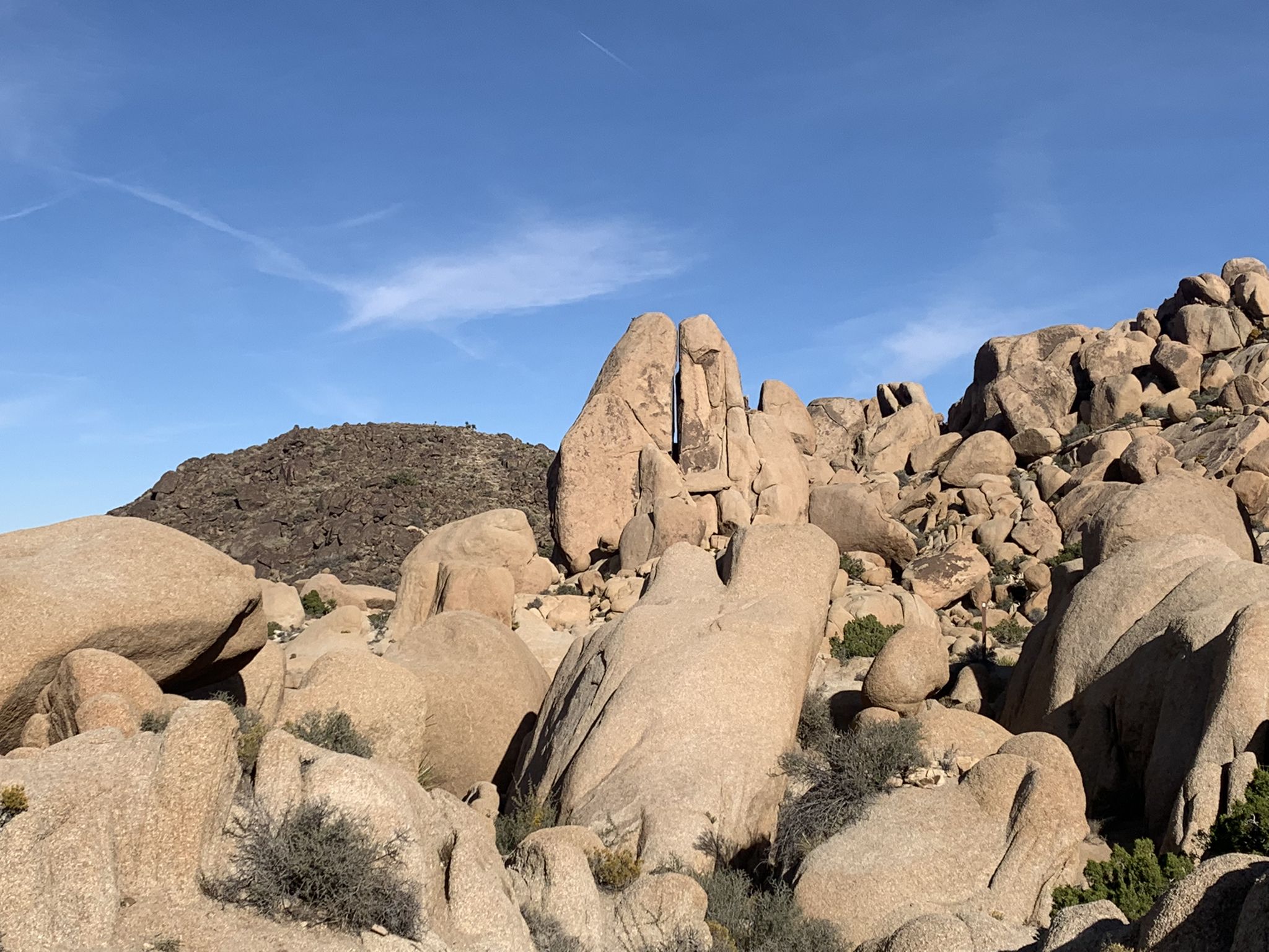 Dramatic rock formations, including a tall split boulder, under a clear blue sky. - Eagle Cliff Mine via Split Rock