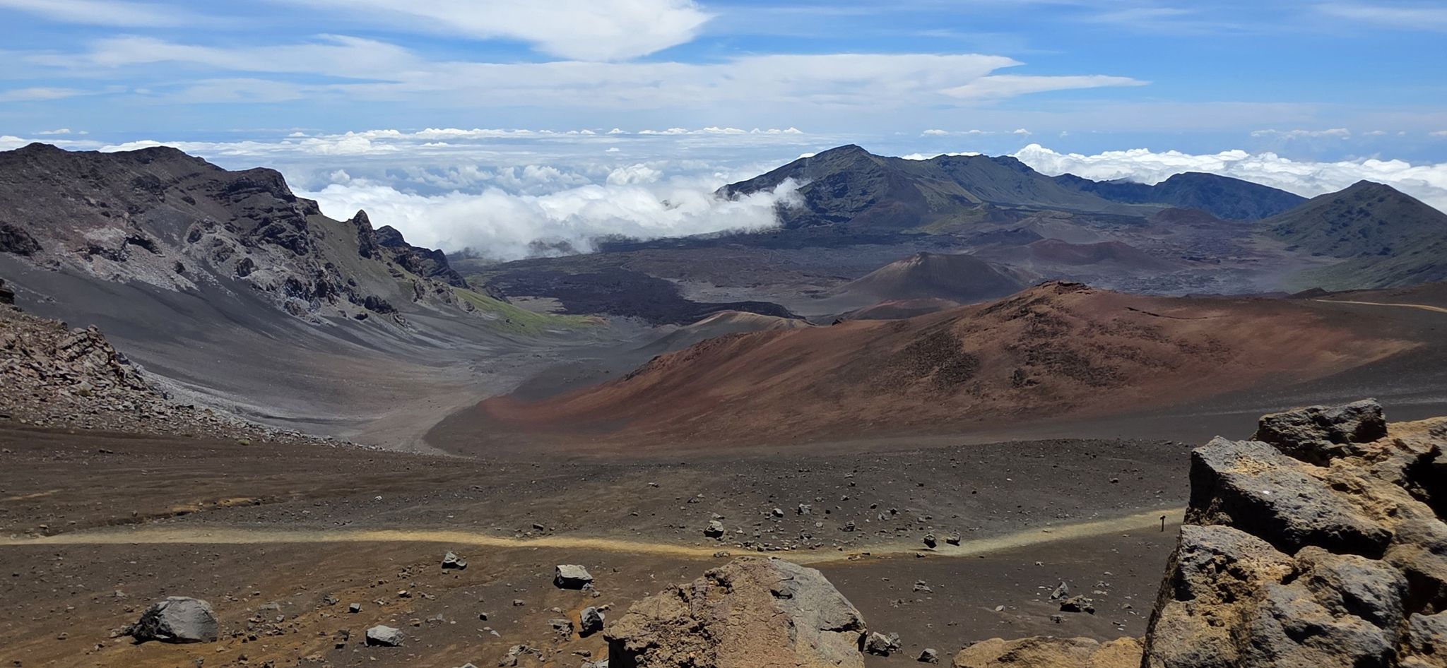 Vast volcanic landscape with colorful craters, clouds, and a winding trail. Bright daylight. - Sliding Sands and Halemau'u Trail Loop