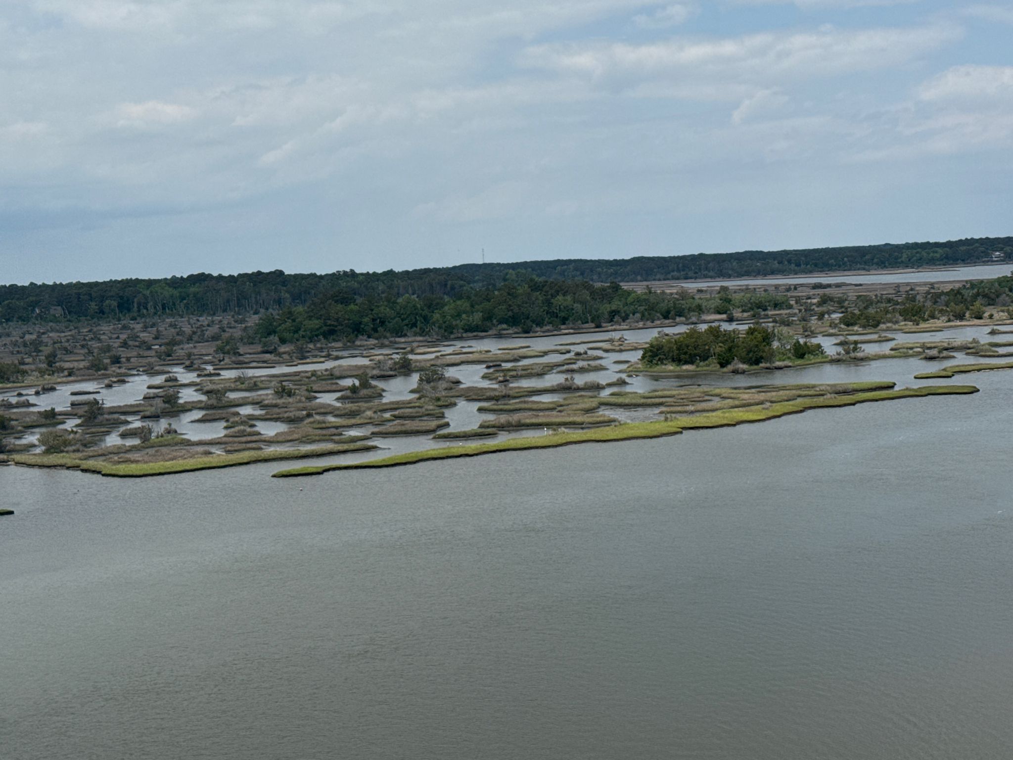 Aerial view of a wide river with numerous grassy marsh islands under cloudy skies. - East Coast Greenway: Jacksonville to North Topsail Beach