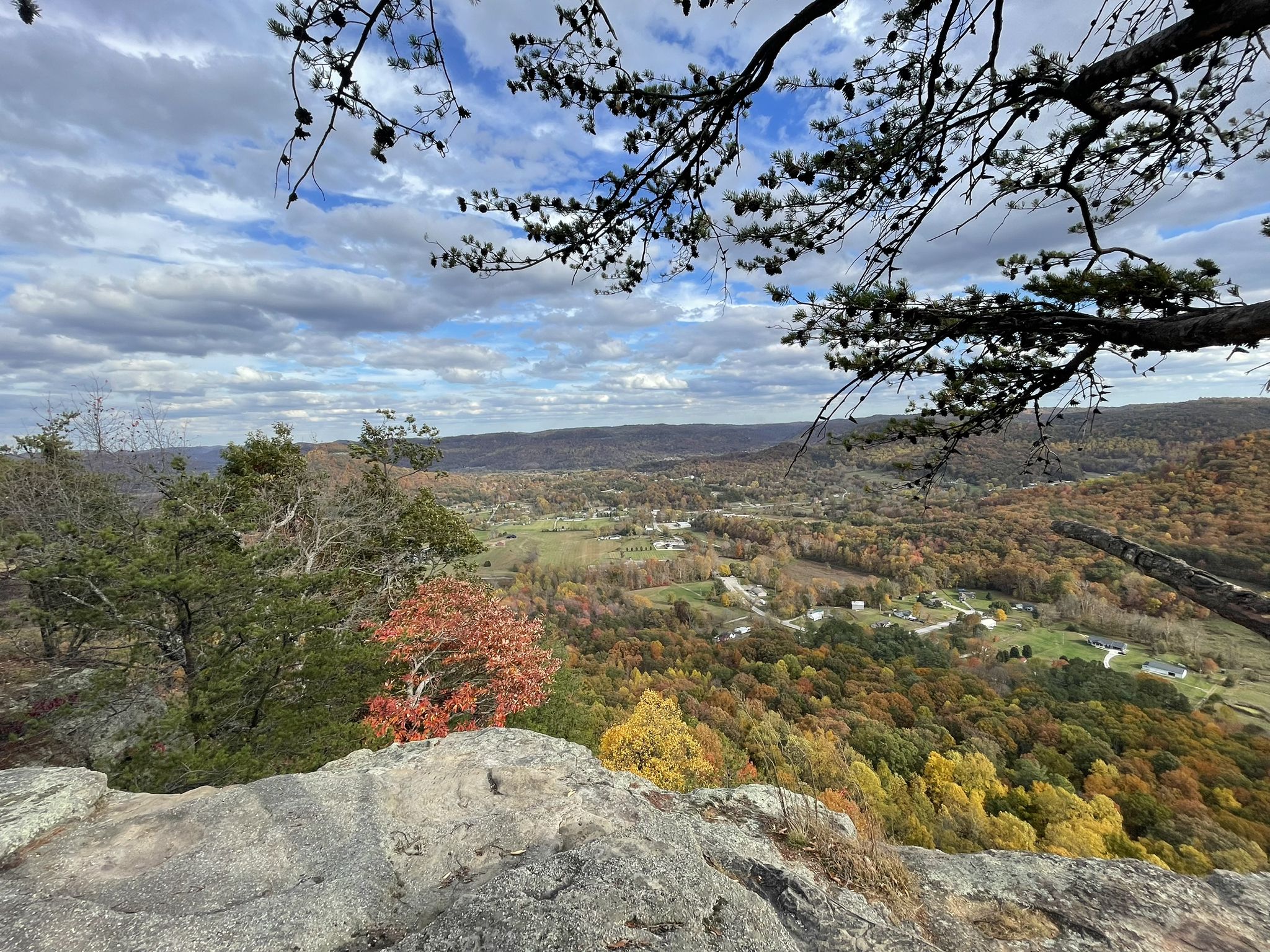 Autumn valley view from a rocky cliff under a partly cloudy sky. - Indian Fort Mountain – East Pinnacle loop from West Barton Trail