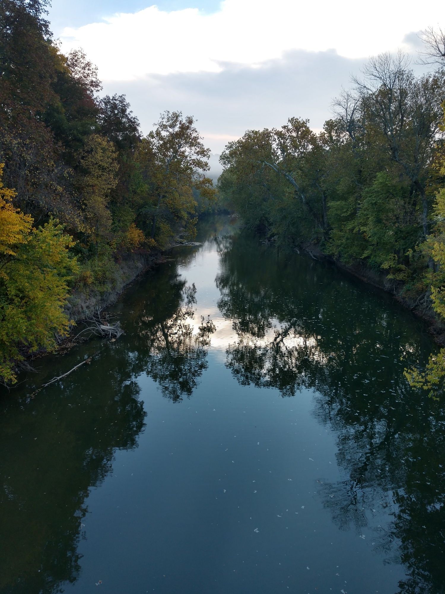 River reflecting autumn trees under a cloudy sky. - Frisco Highline Trail