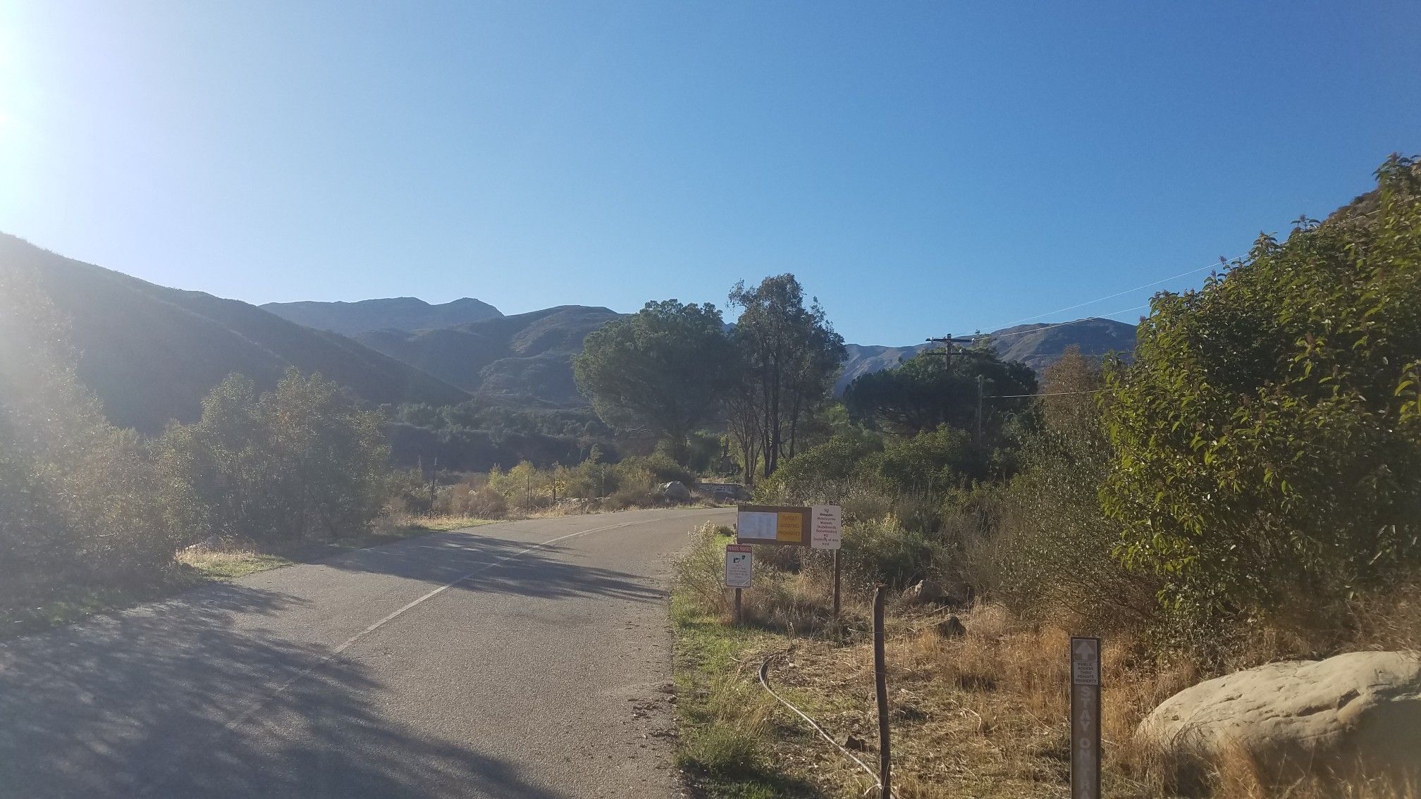 Sunny mountain landscape with a road fork and distant peaks under clear sky. - Murietta Trail and Matilija Divide Trail Loop