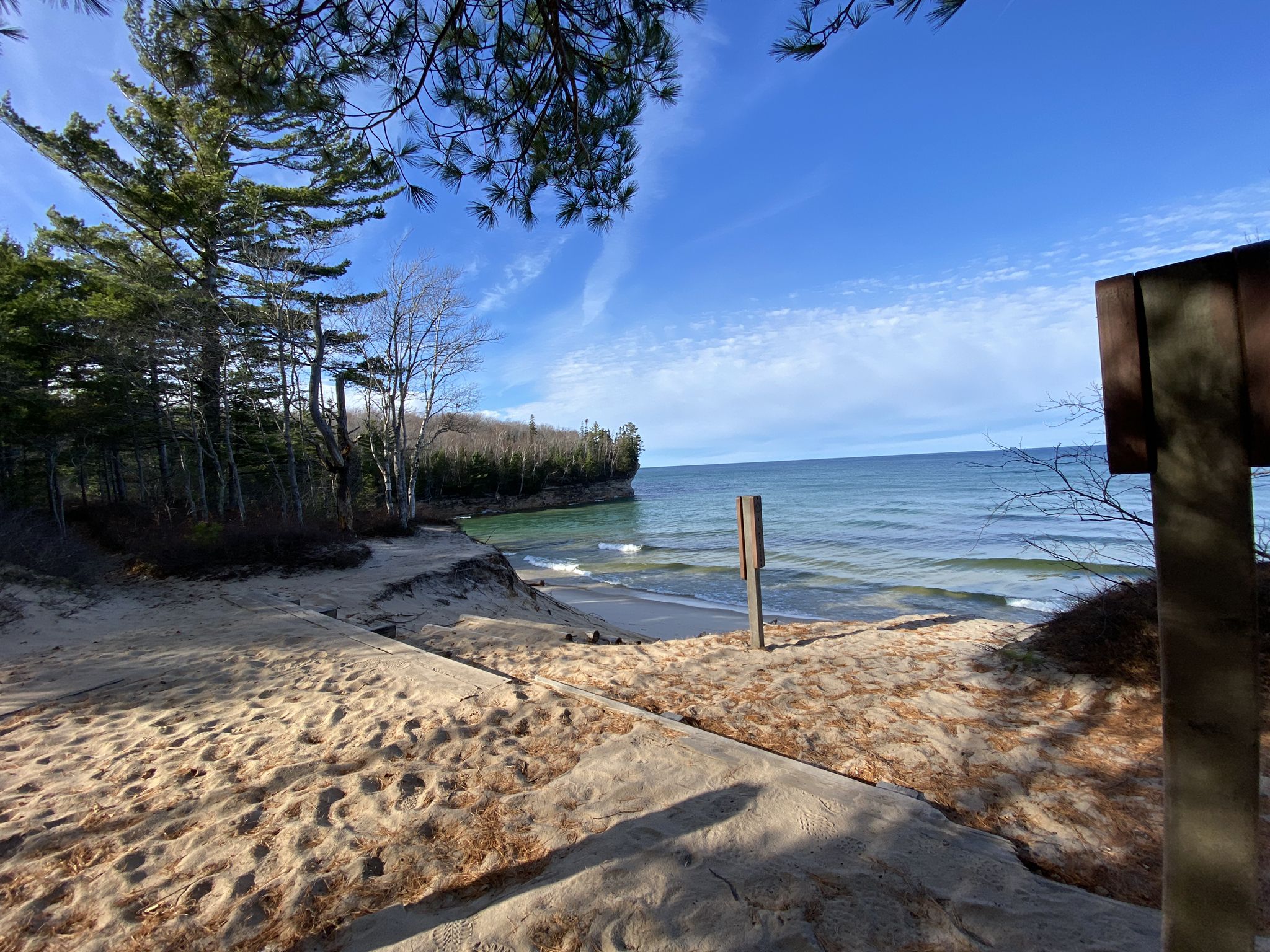 Sandy beach with calm water, distant cliffs, and blue sky. - Chapel Falls – Chapel Rock loop from Chapel / Mosquito