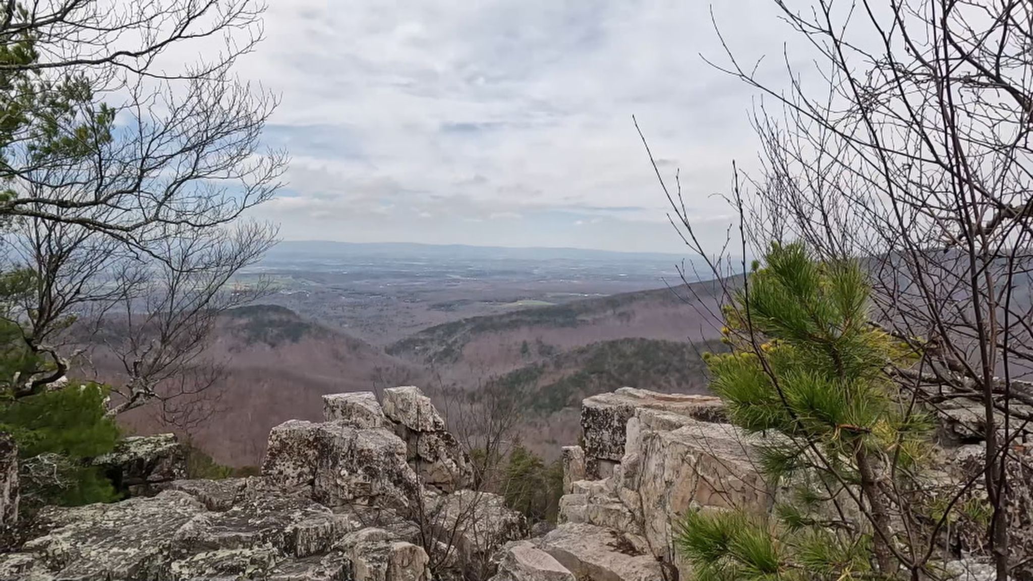 Overcast view from a rocky mountain ledge over bare winter forests. - Calvary and Chimney Rocks Trail