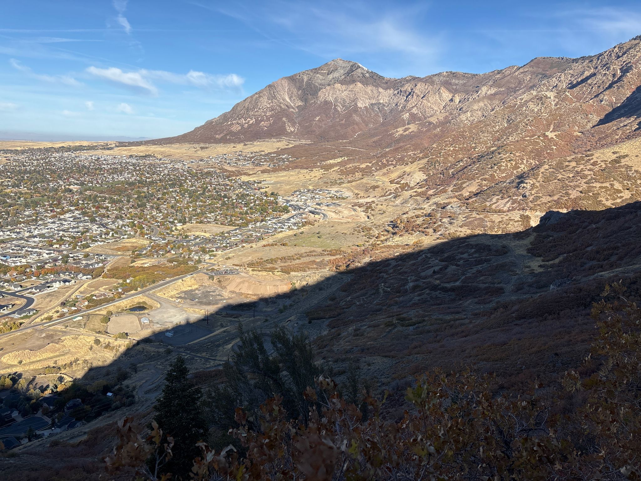 Expansive view of a city in a valley, shadowed mountain in foreground. - Coldwater Canyon BST