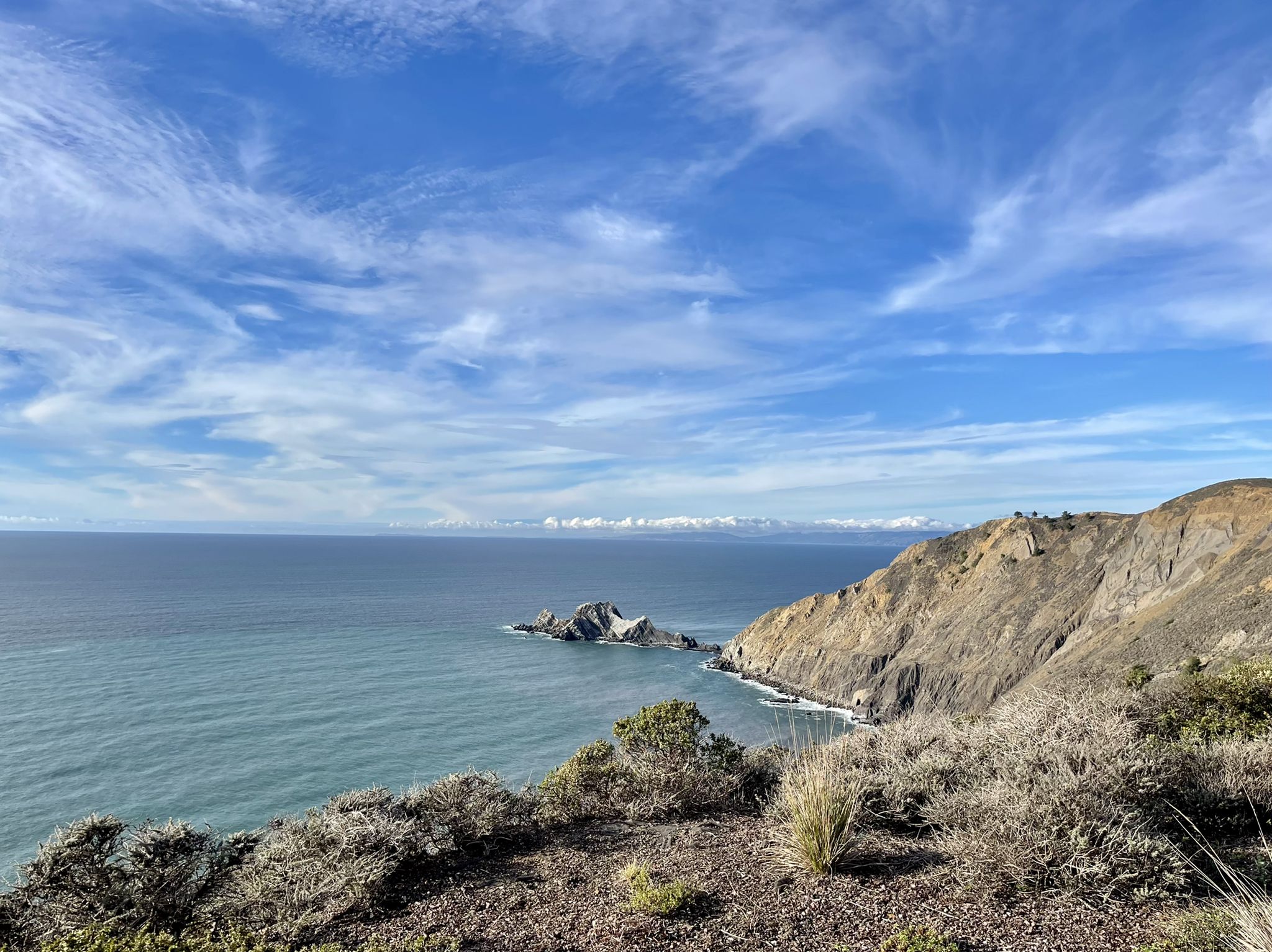 Ocean vista with rocky cliffs, sea stacks, and a partly cloudy sky. - Egg Rock — Devil's Slide – Devil's Slide Trail loop from Pacifica