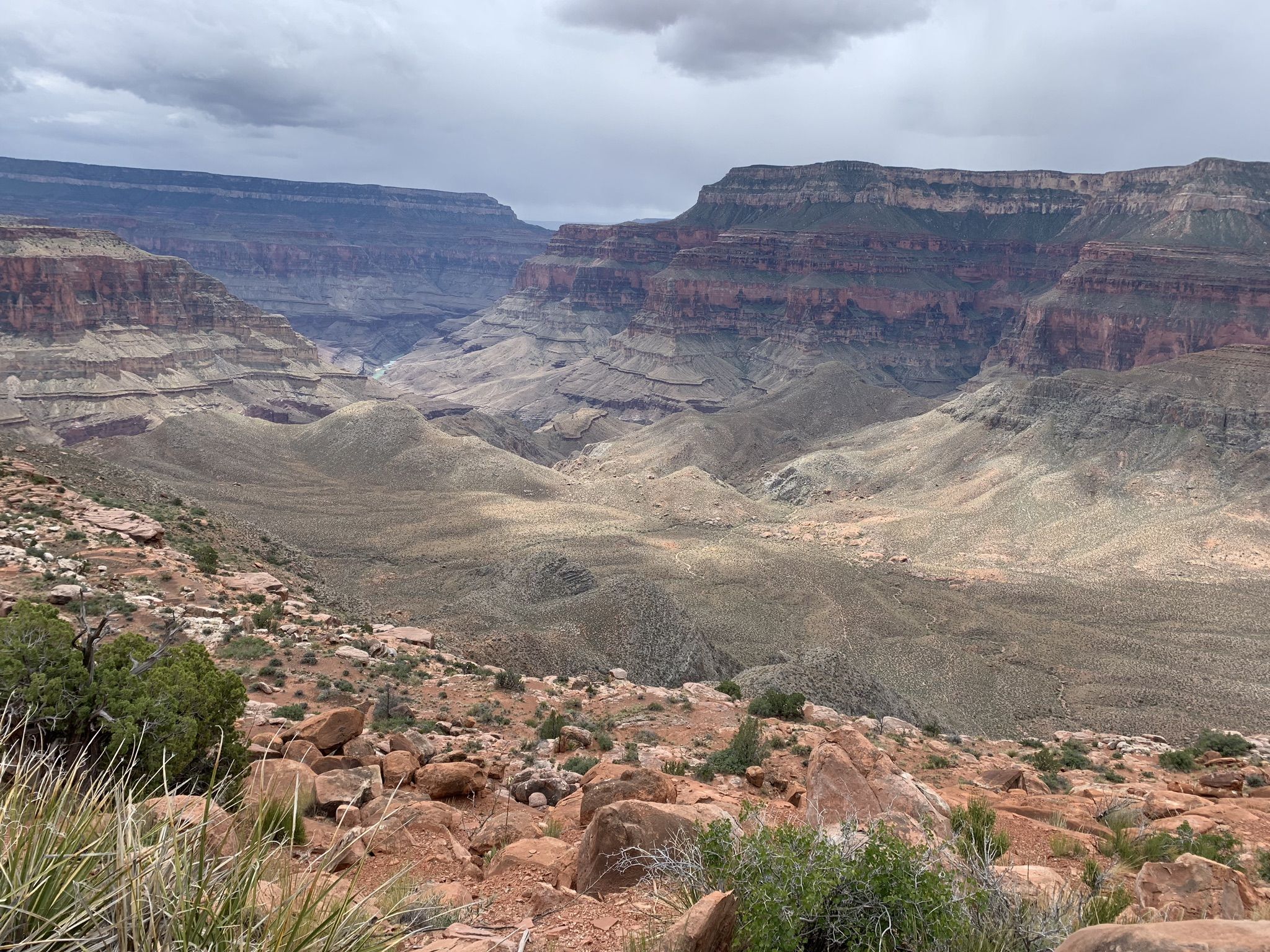 Expansive canyon view with layered rock formations under a cloudy sky. - Bill Hall and Thunder River Trail to Thunder Spring