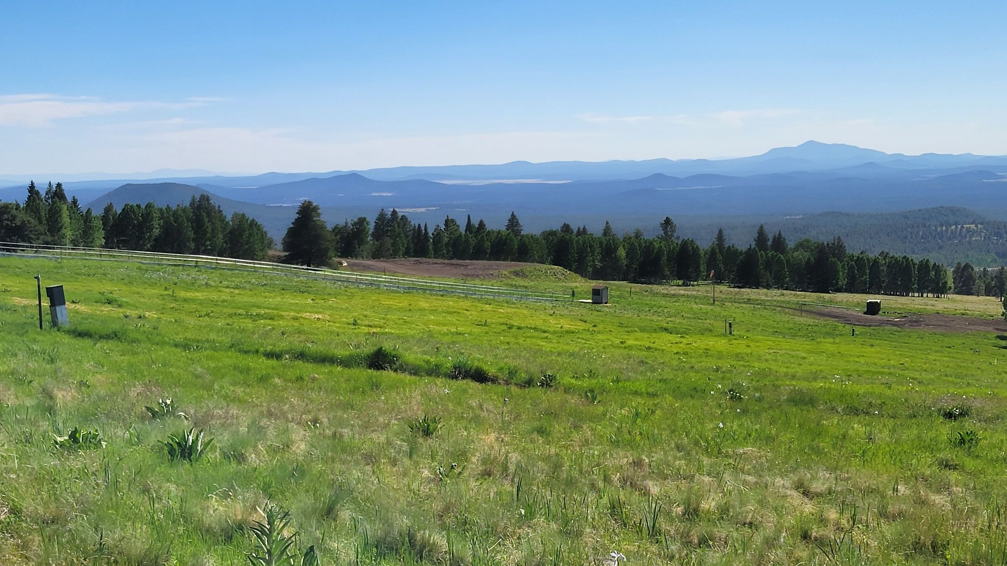 Rolling green hills and distant forests under a bright, clear blue sky. - Humphreys Peak Trailhead – Arizona Trail Intersection loop from Arizona Snowbowl