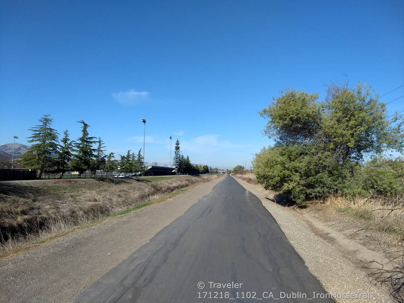 Long paved path stretching into the distance under a clear blue sky. - Iron Horse and Tassajara Loop