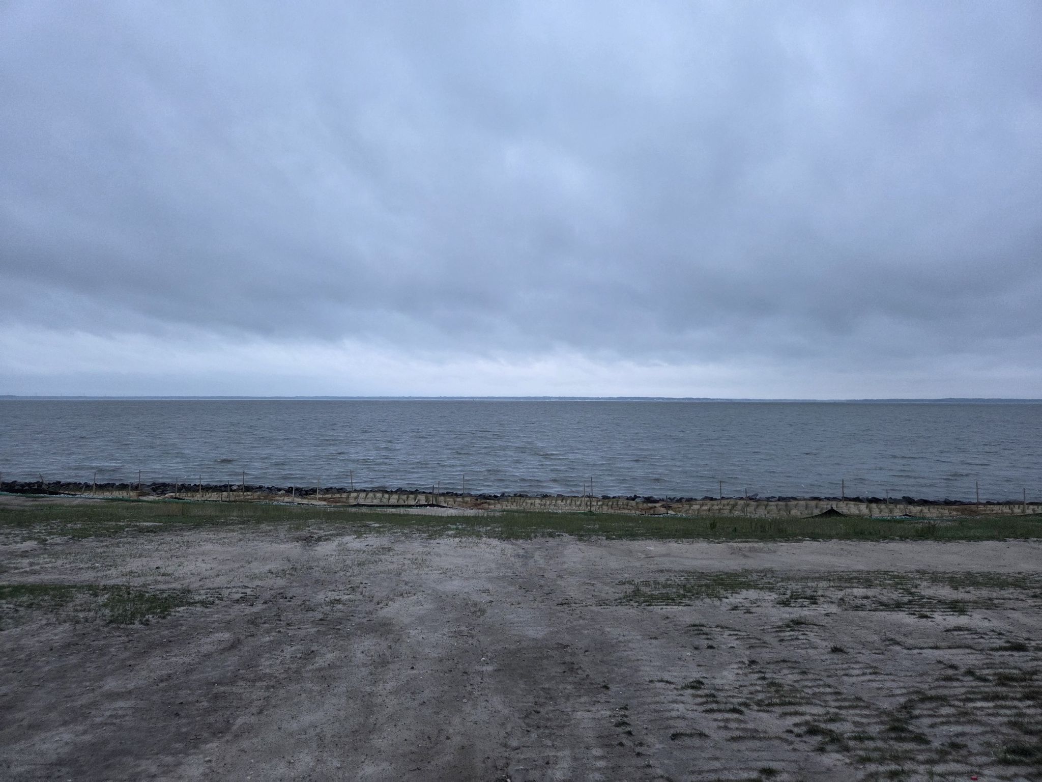 Wide view of a large body of water under a cloudy gray sky. - USS Monitor Exhibit – The Mariners' Museum loop from Hampton Coliseum
