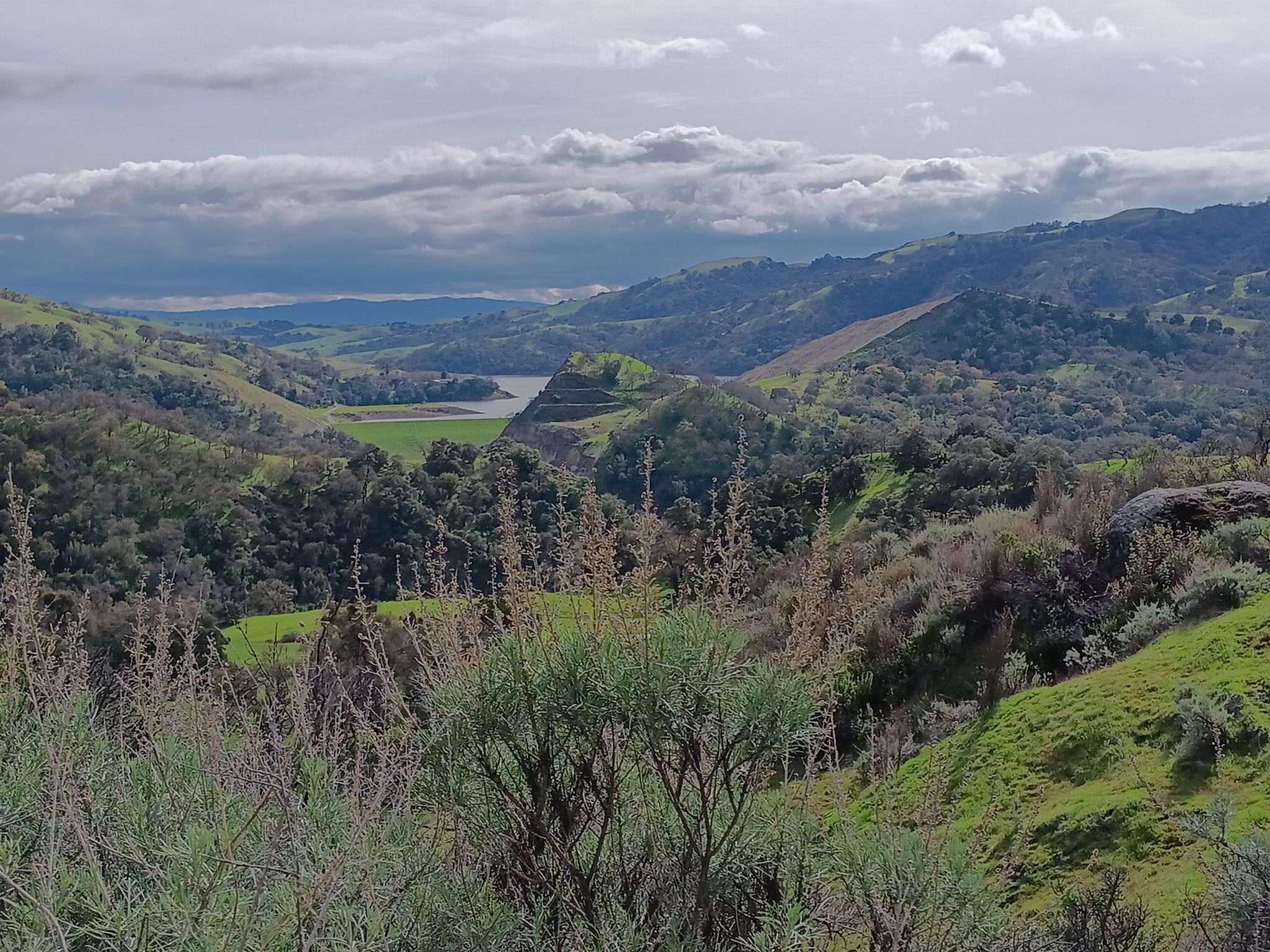 Hilly landscape with a distant lake under a cloudy sky. - Indian Joe Creek, Vista Grande, Eagle View and Canyon View Loop