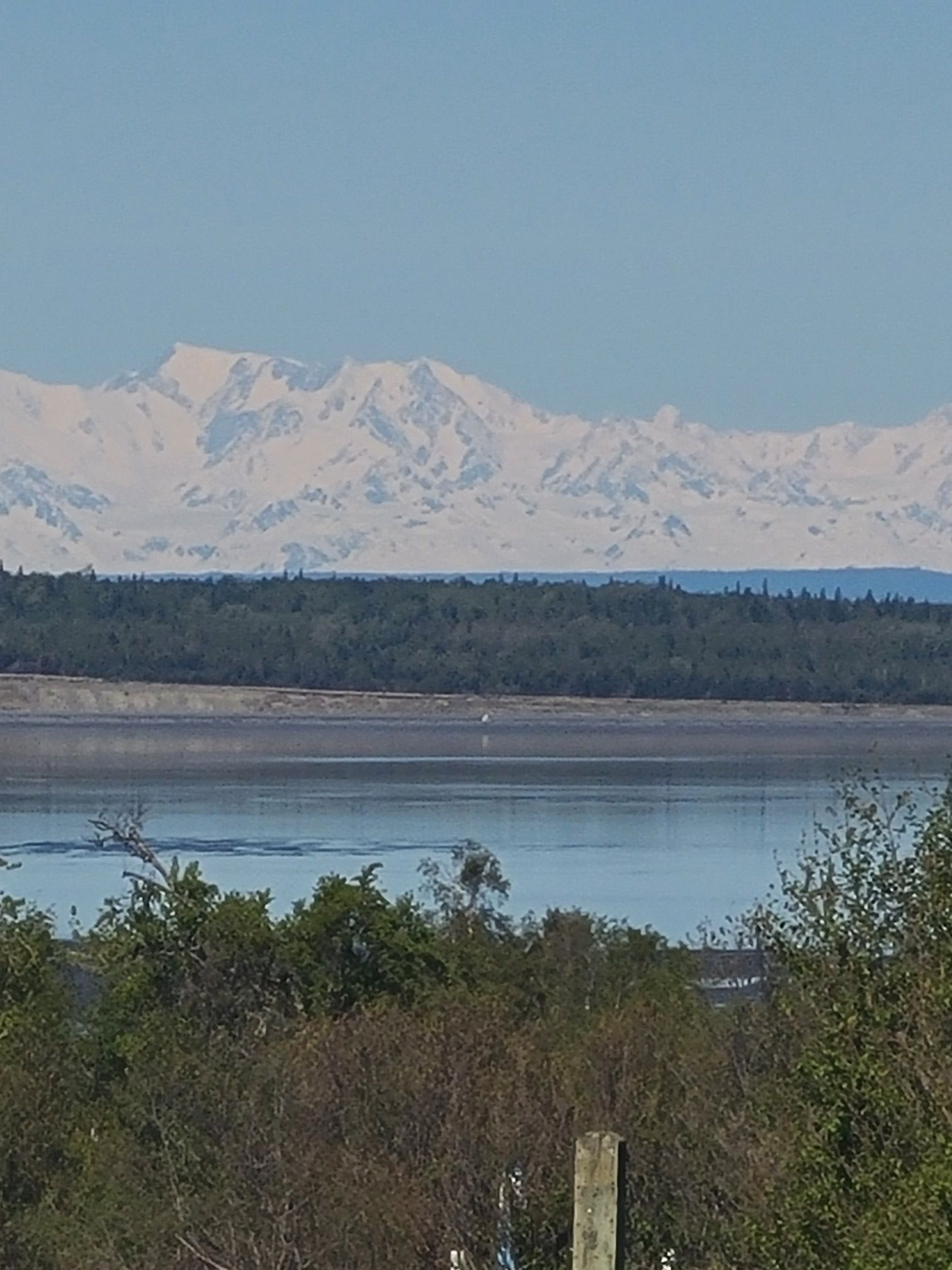 Majestic snow-capped mountains rise across a calm body of water. - Kincaid Park Hill – Kincaid Chalet loop from Country Lane Estates