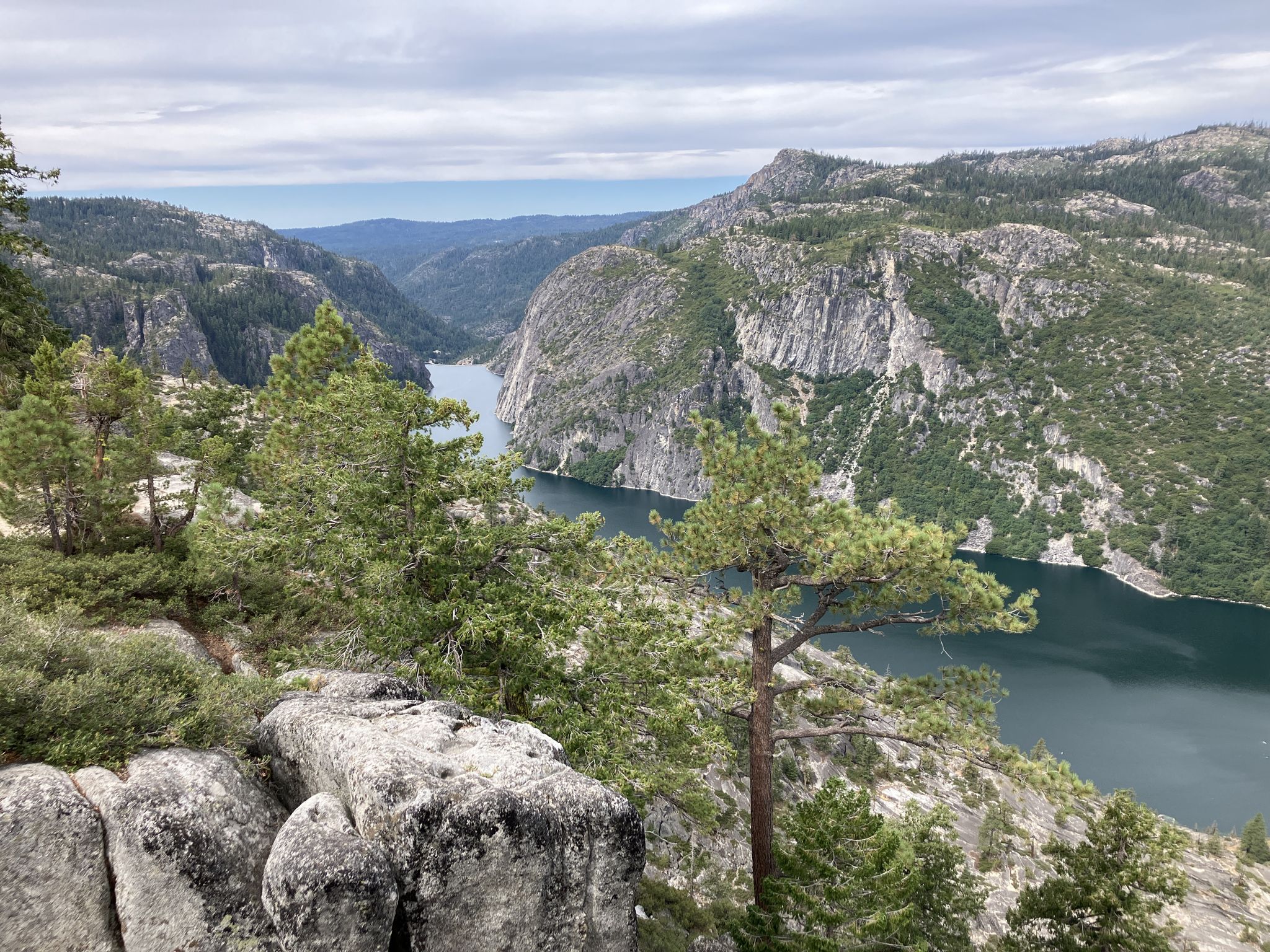 River winding through a rocky, forested valley under an overcast sky. - Donnell Vista Trail