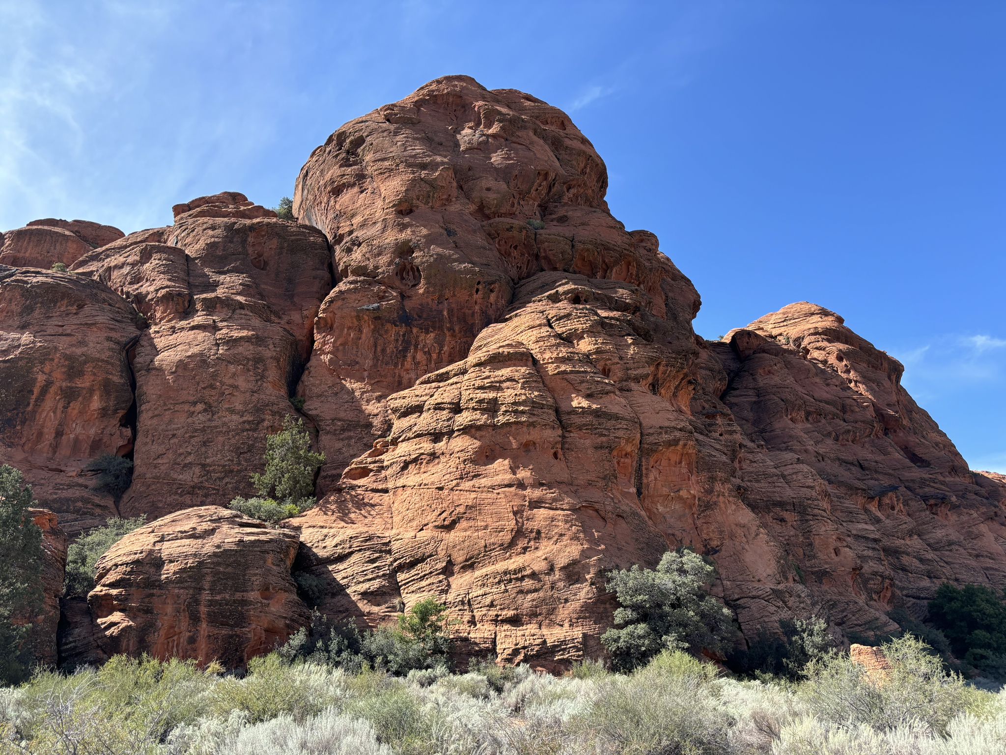 Massive, rugged red rock formation rises under a clear, bright blue sky. - West Canyon Road loop from Snow Canyon Visitor Center