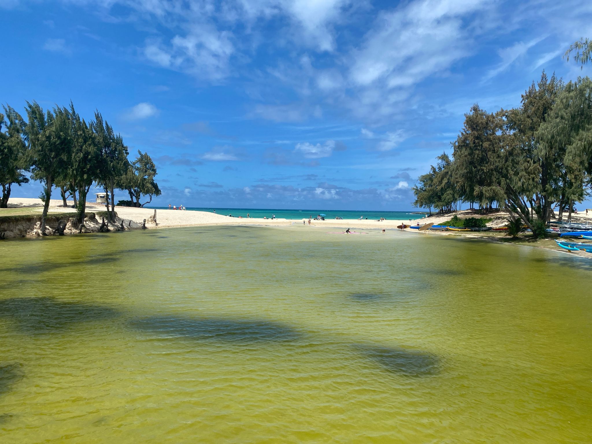 Bright sunny day over a green lagoon meeting a sandy beach and blue ocean. - South Lanikai via Kailua Beach loop