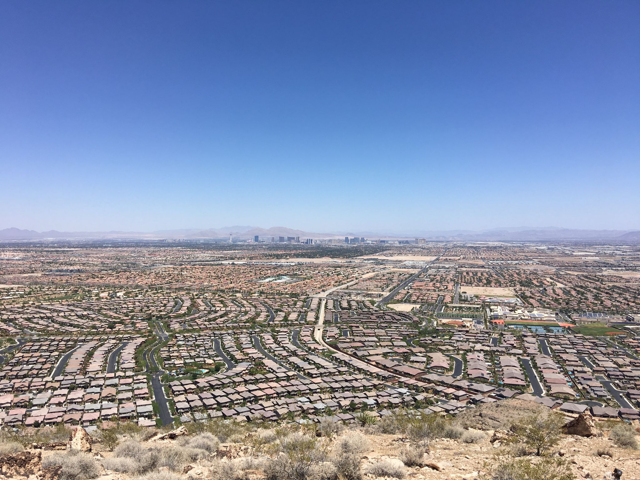 Expansive view of a city and residential areas from a high desert hill. - Benchmark Trail – Permagrin Trail loop from Bishop Gorman Catholic High School